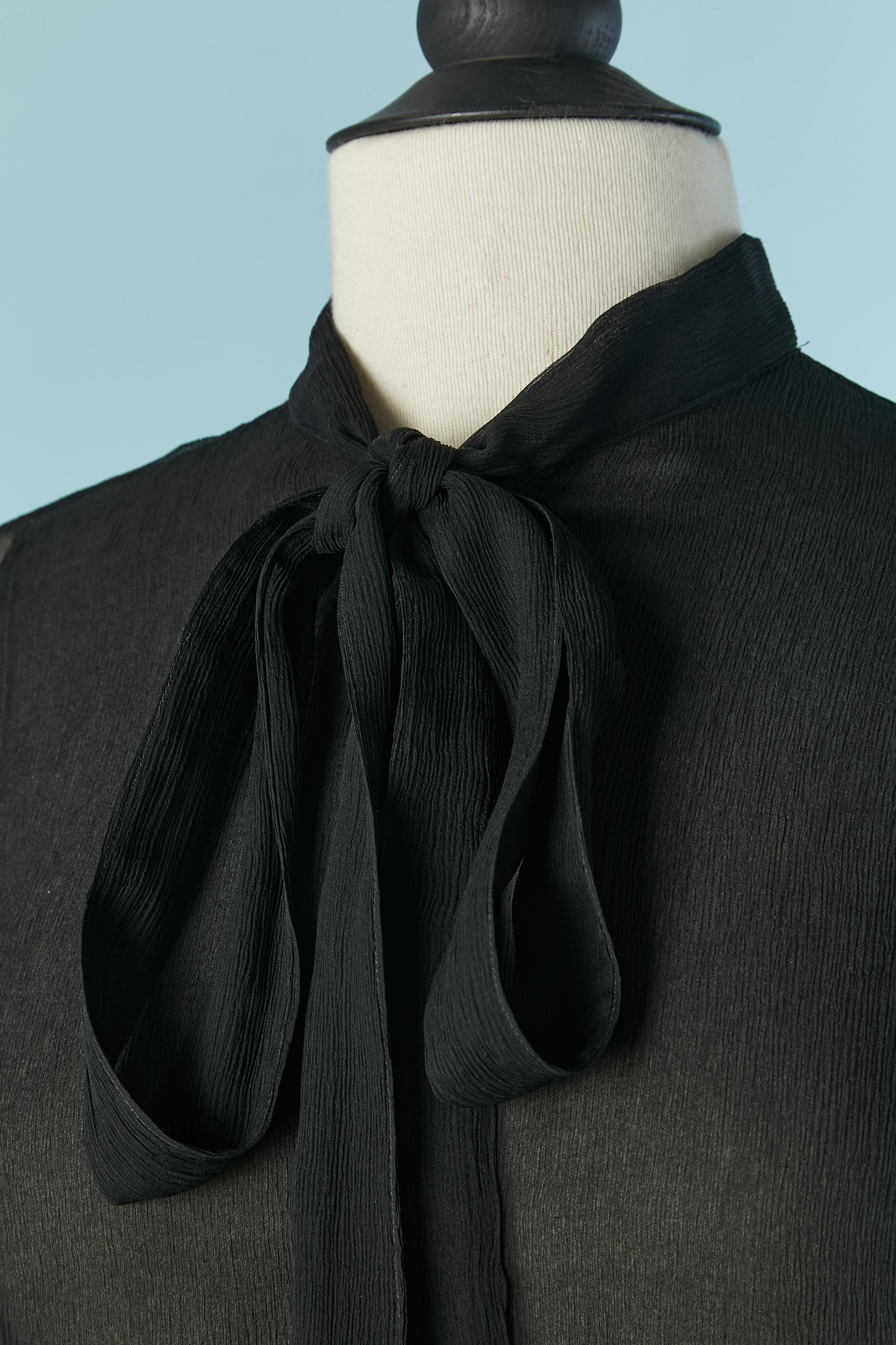Black see-through silk chiffon shirt with bow tie. 
Button and buttonhole closure on the middle front and on the cuffs 
SIZE 38 (Fr) M 