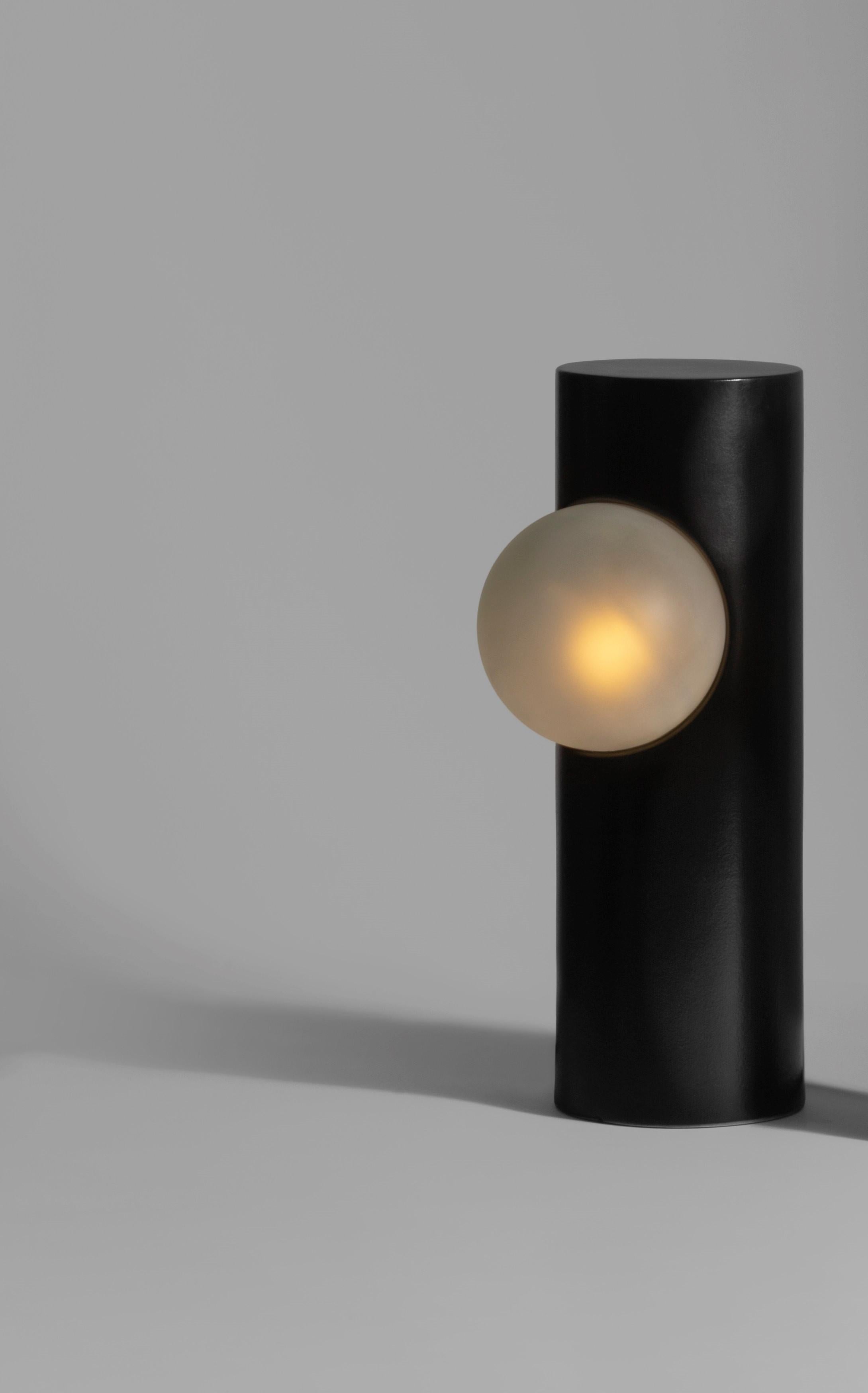 Black Semigloss Post Lamp by Subject Bureaux
DImensions: ? 12.7 x H 38 cm
Materials: Handmade Slip Cast Stoneware, Glass.

The Post Lamp was derived from the exercise of consistently being aware of ones environment. By being curious of the
