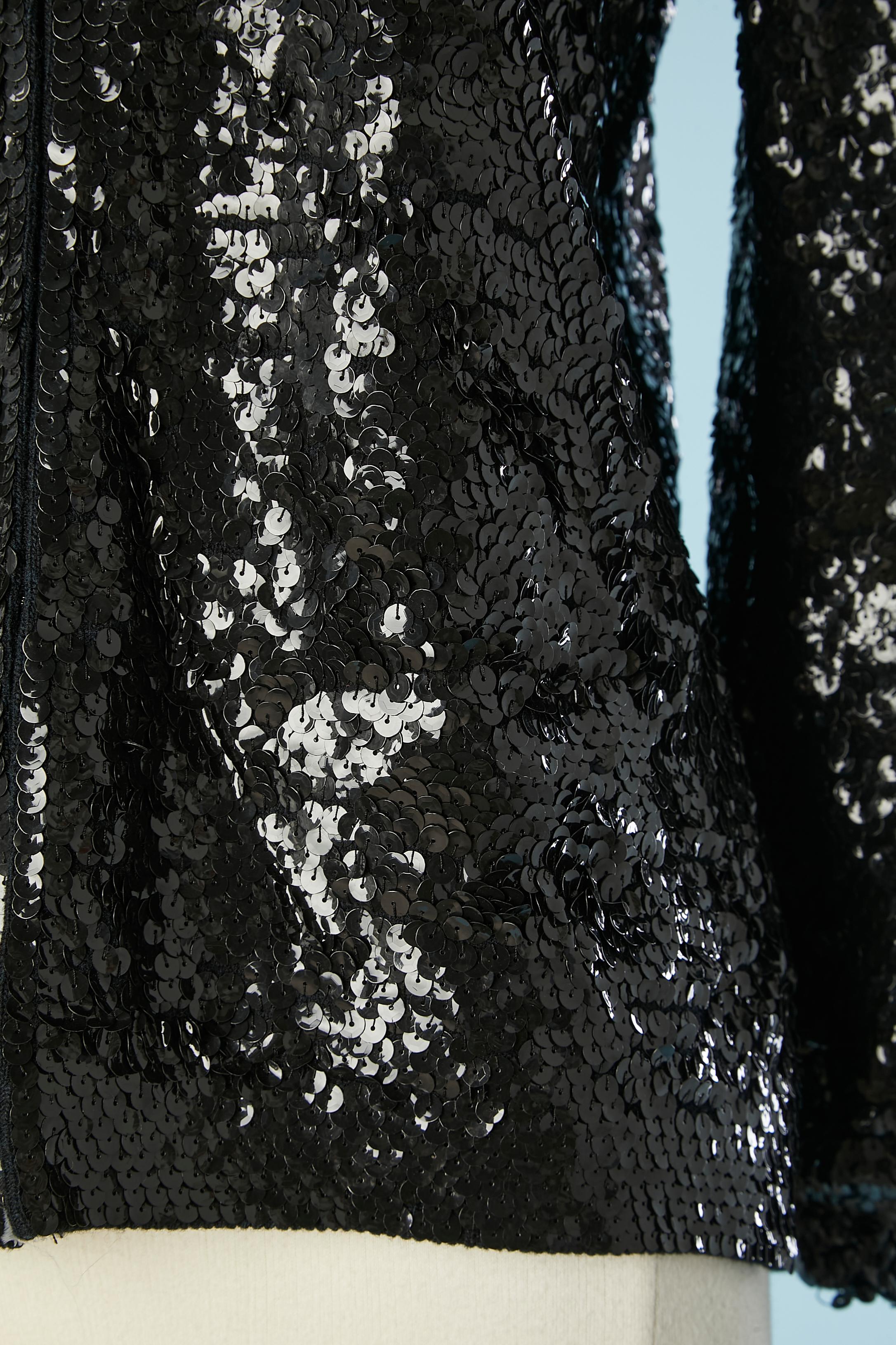 Black sequin edge to edge evening cardigan with hook&eye closure. Wool base and acetate lining. Split on both side, length= 9cm
Knit edge in the inside bottom edge of the sleeves and in the inside bottom of the jacket. 
SIZE 42 / L
