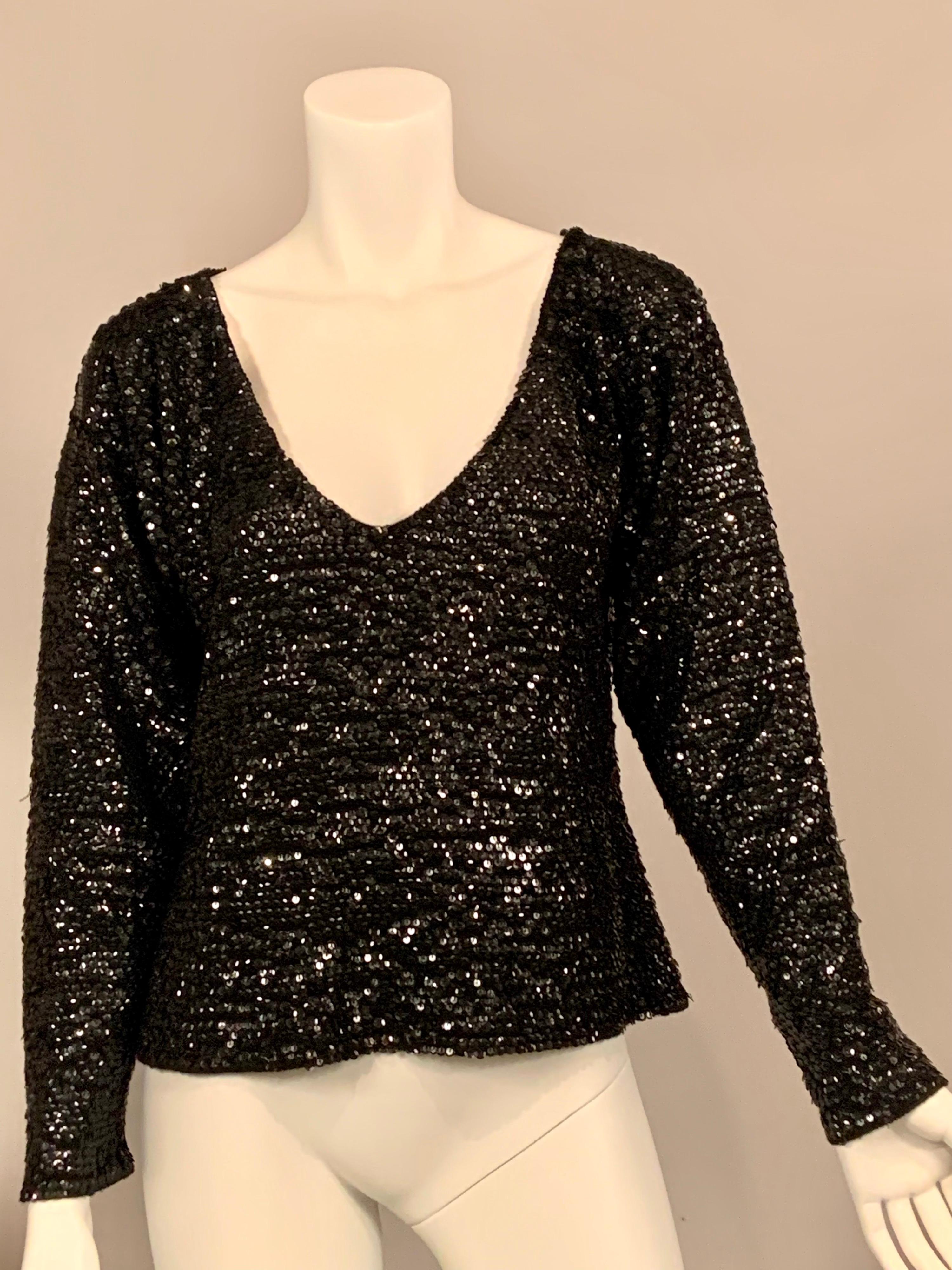 Smothered in black sequins, this soft wool sweater has a V neckline and long sleeves. It will dress up any skirt, pair of pants or jeans for a fun evening look.  It is in excellent condition, there are no labels so please check the measurements. 