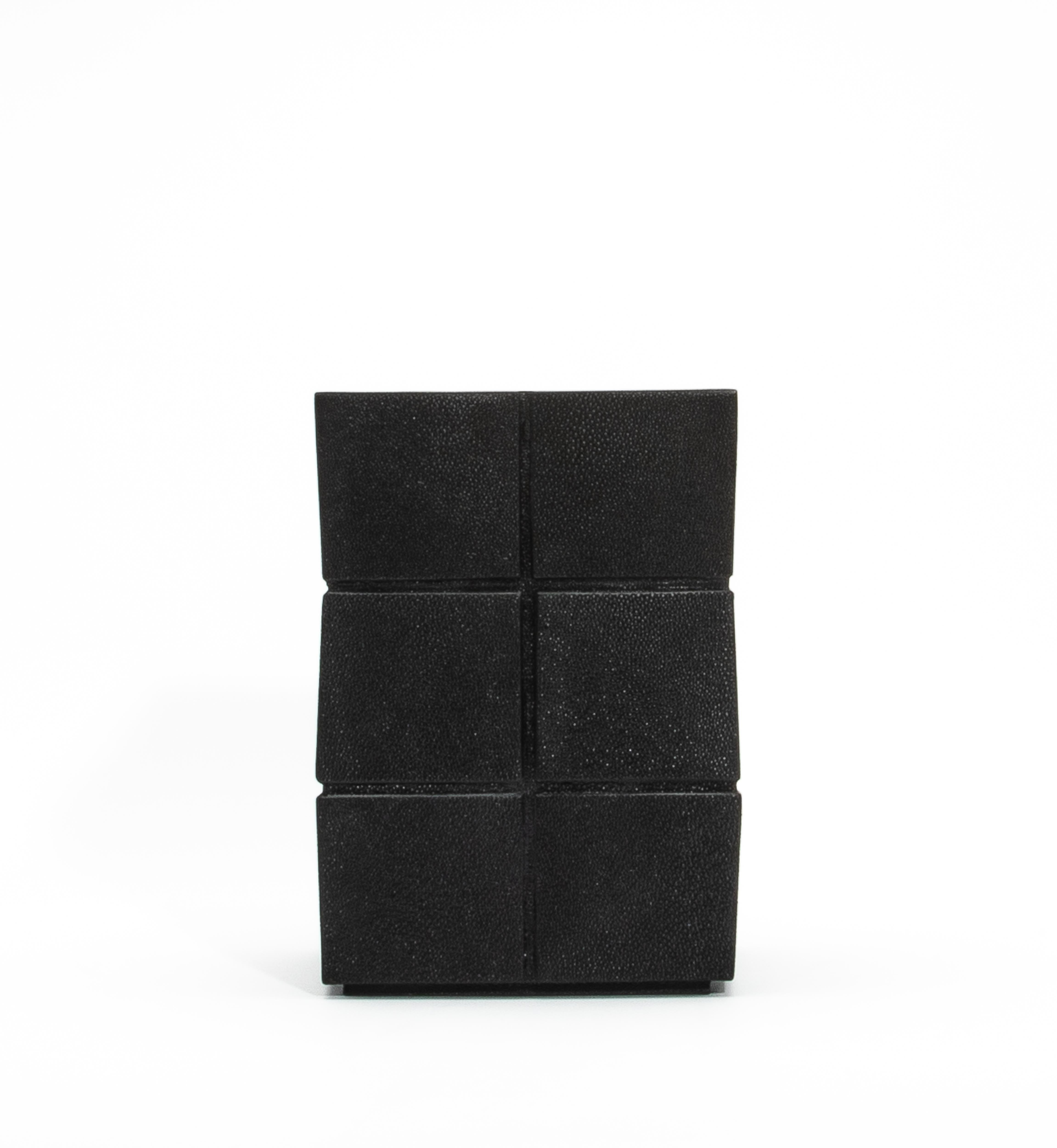 The Black Shagreen Rhomboid Waste Bin by R&Y Augousti is a masterpiece of functional design, combining luxurious materials and artisanal craftsmanship. Its exterior is adorned with meticulously hand-applied black shagreen, creating a tactile surface