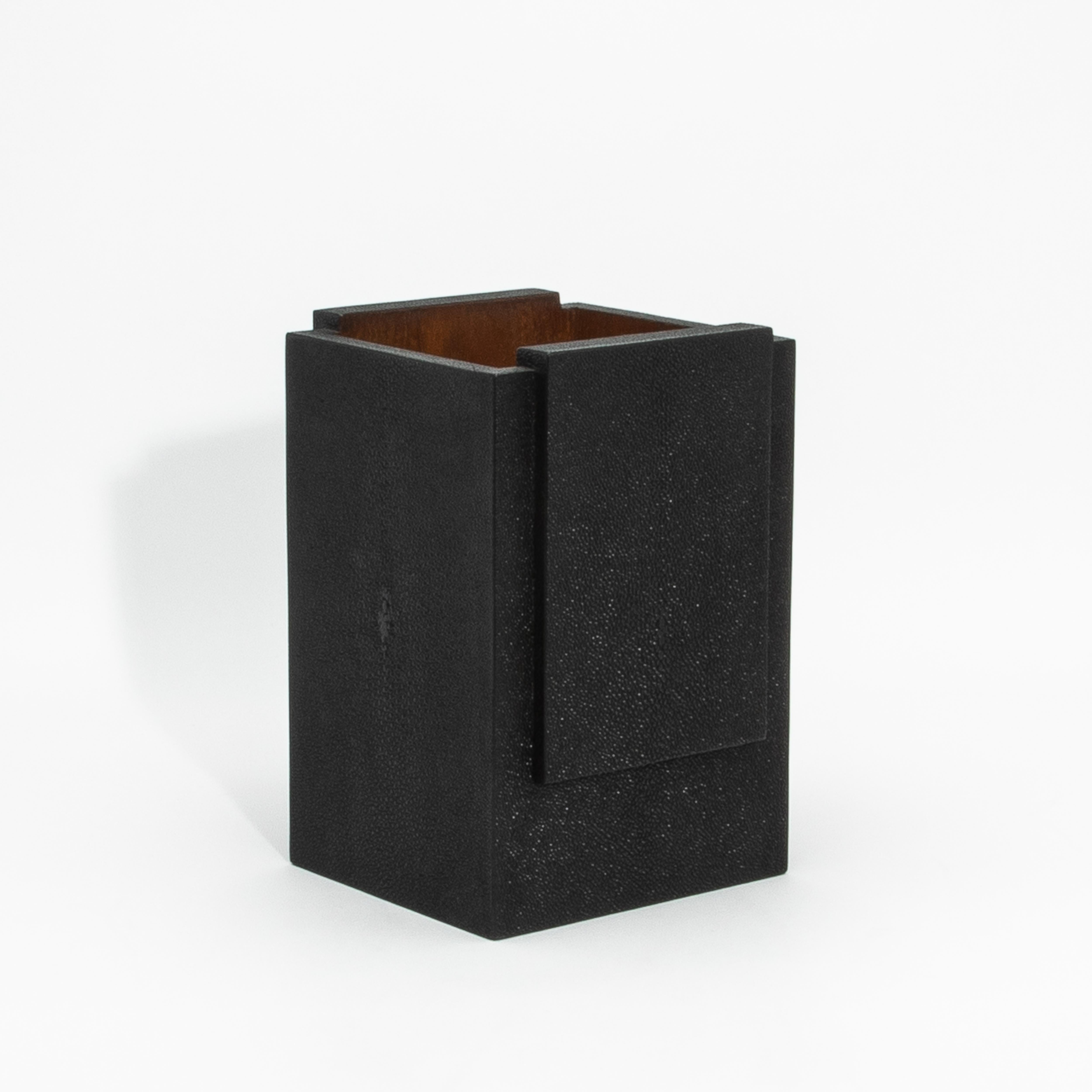 The Black Shagreen Waste Bin with Wood Interior by R&Y Augousti is a stunning blend of luxurious craftsmanship and functionality. Its exterior, crafted from hand-selected black shagreen, boasts a rich, textured finish that exudes sophistication,