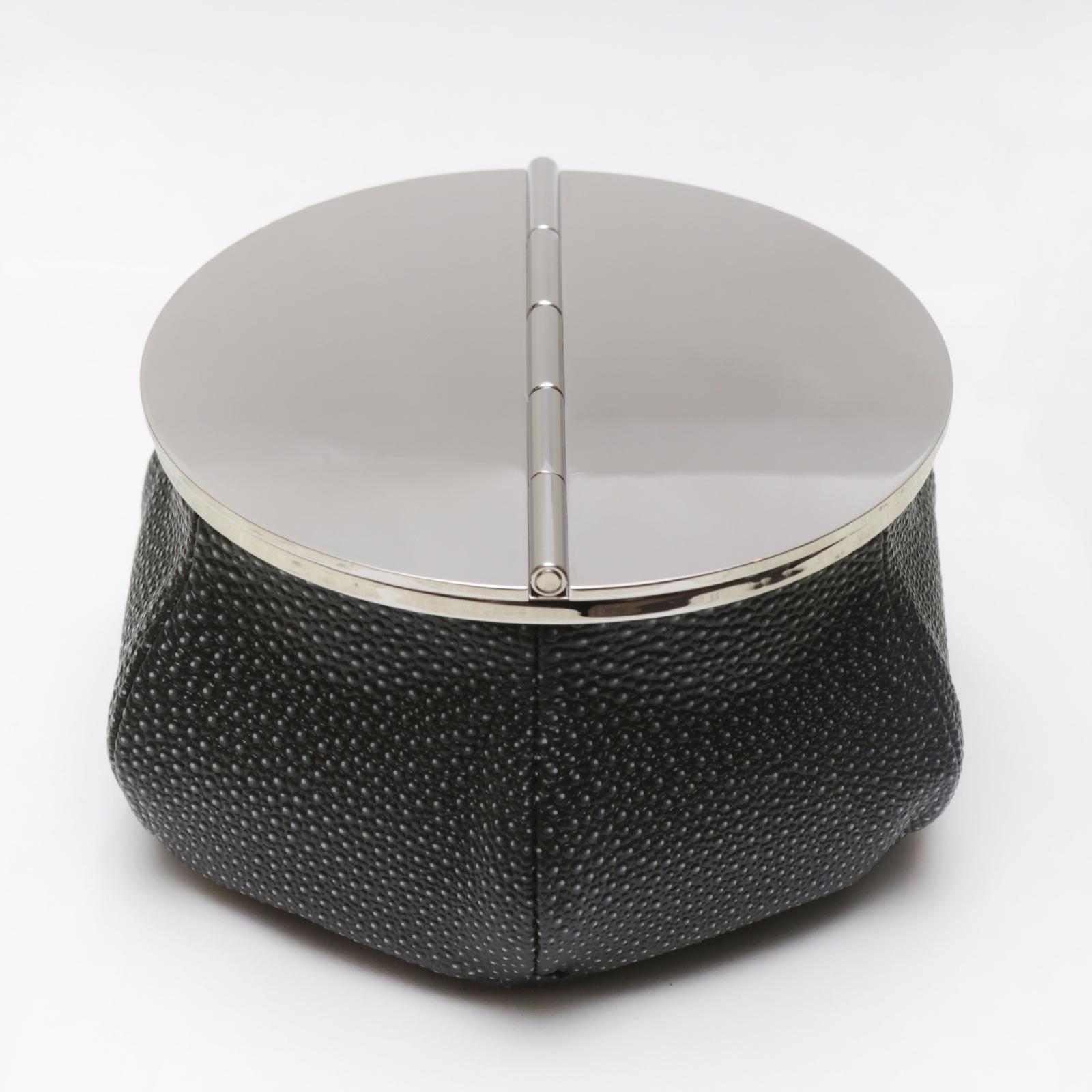 Ashtray Black Sharkskin 4 Cigars Yachting with bag covered 
with black shagreen finish printed on calfskin with black stitching. 
Bag filled with 1 kg micro metal balls that give high stability.
Ashtray top with 2 openable lids in solid brass in