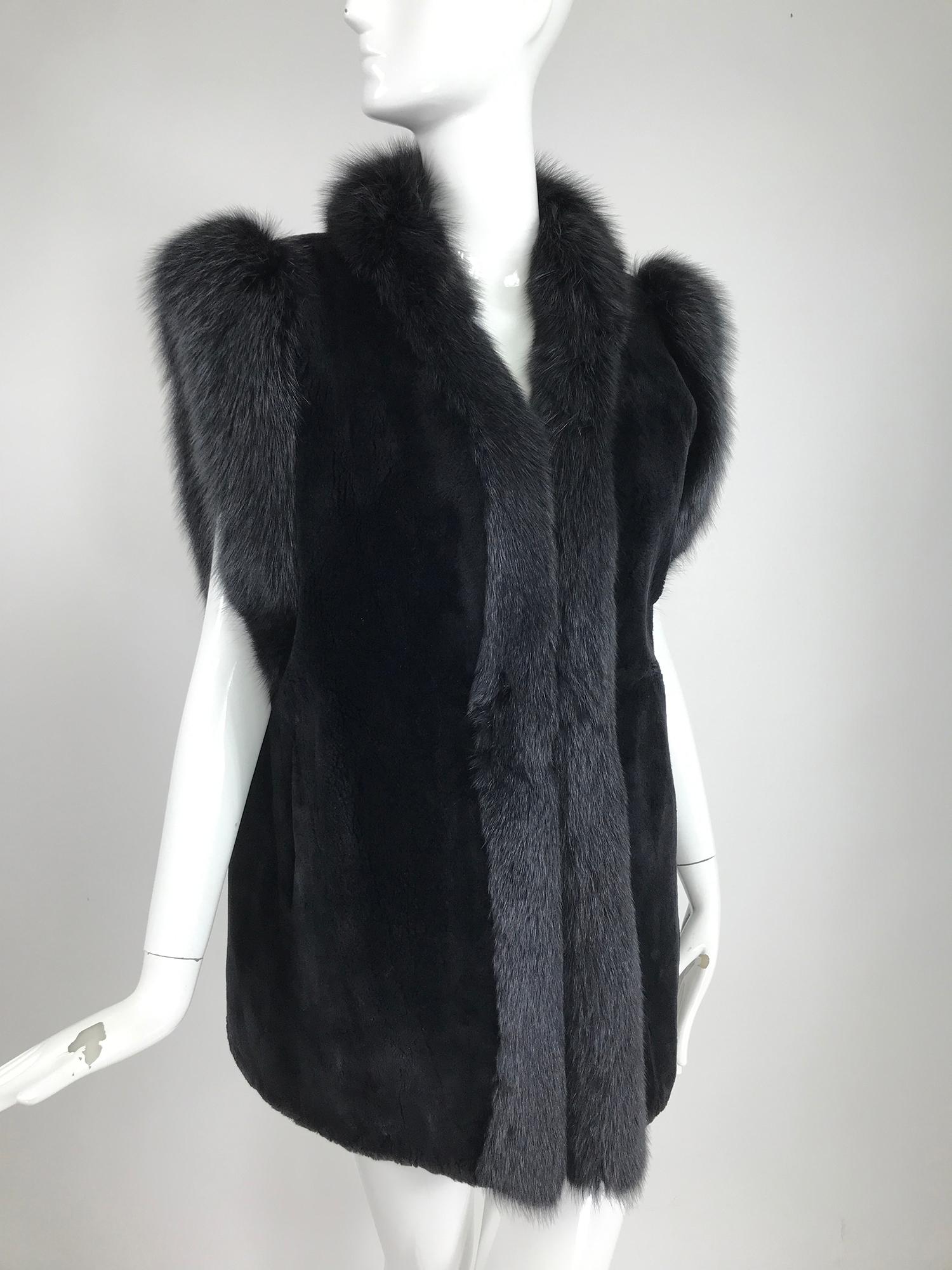 Black sheared beaver with fox trim Gilet or vest, vintage from the 1970s. Beautiful and soft sheared beaver has arm openings and front facings of black fox. Fully lined in black taffeta. Deep arm openings. Front pockets. Closes at the front center