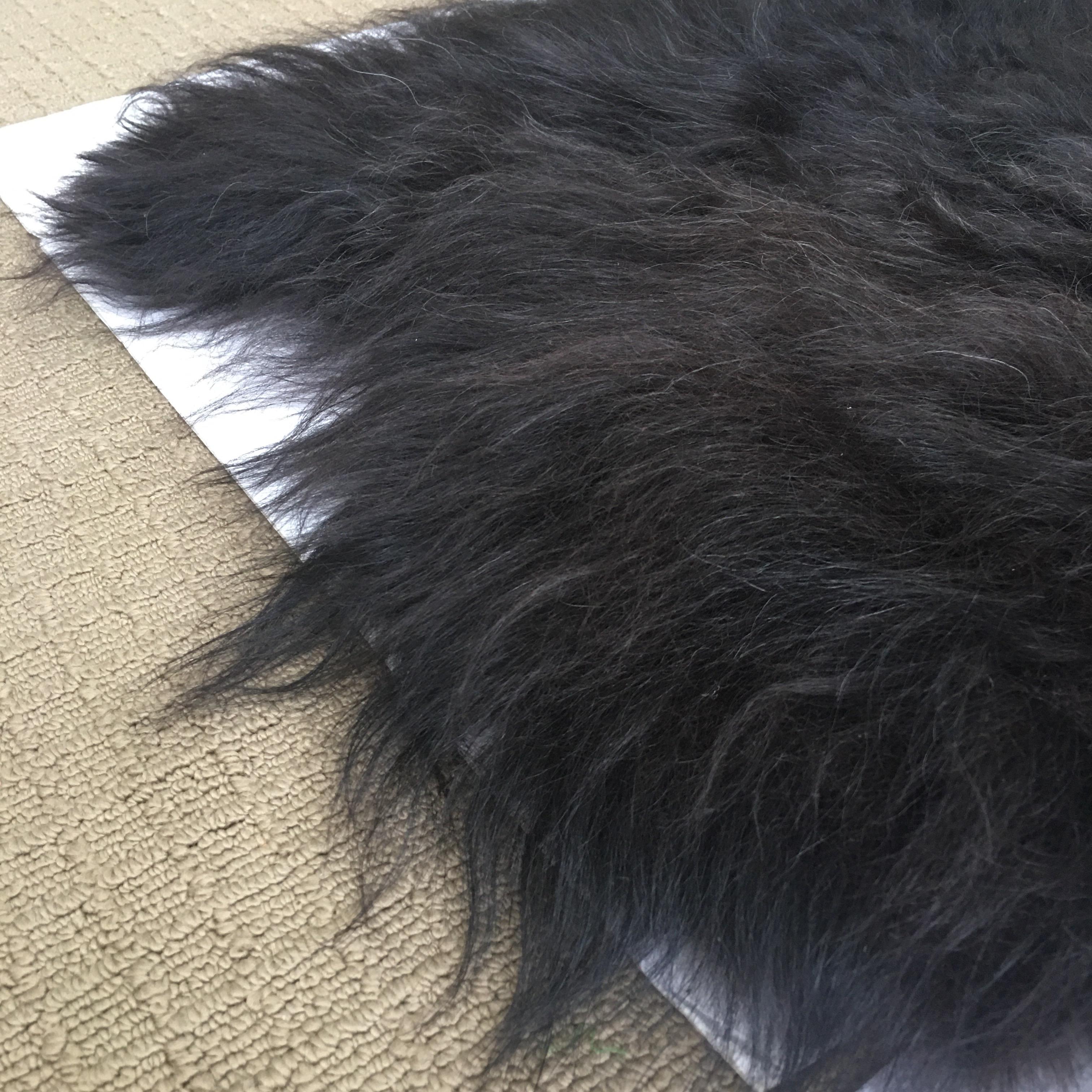 Black organic plush longhair sheepskin fur rug with dark brown highlights. This soft floor covering also makes a beautiful throw for displaying on a chair or sofa. Fur Origin: Iceland. Made in Poland.