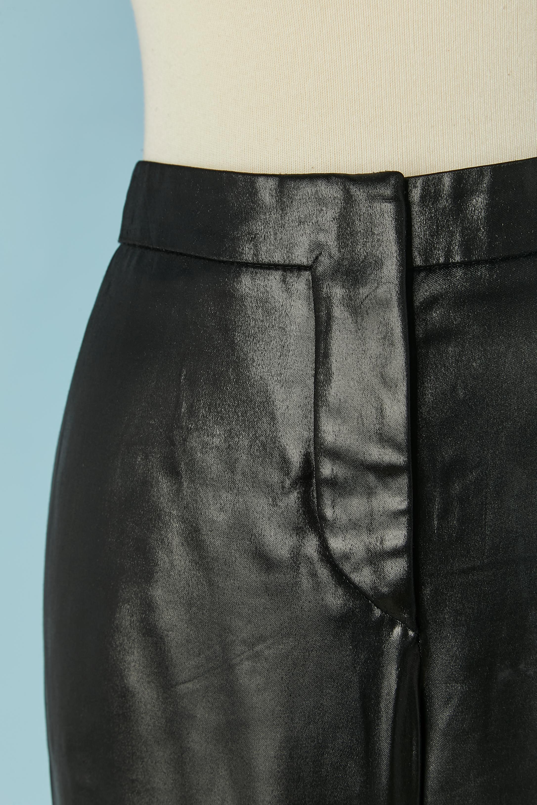 Black shiny satin trouser with back pockets. Zip, hook&eye, snap, branded button and buttonhole closure in the top middle front. 
The  fabric composition tag has been cut
SIZE 42 (Fr) L 