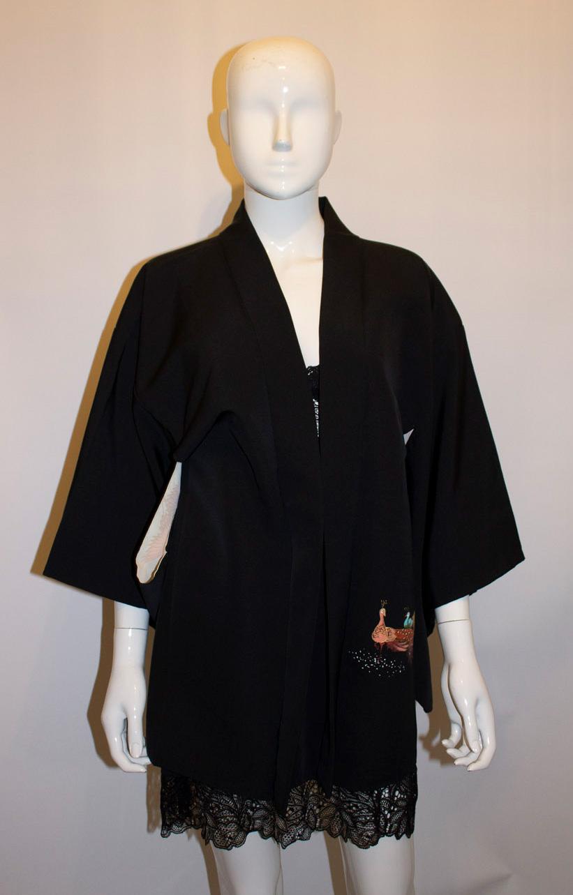A chic and easy to wear black short hari (kimono) , with pheasant decoration that is hand stencilled onto the silk. It has a floral lining.
Measurements: Bust up to 39'', length 30''