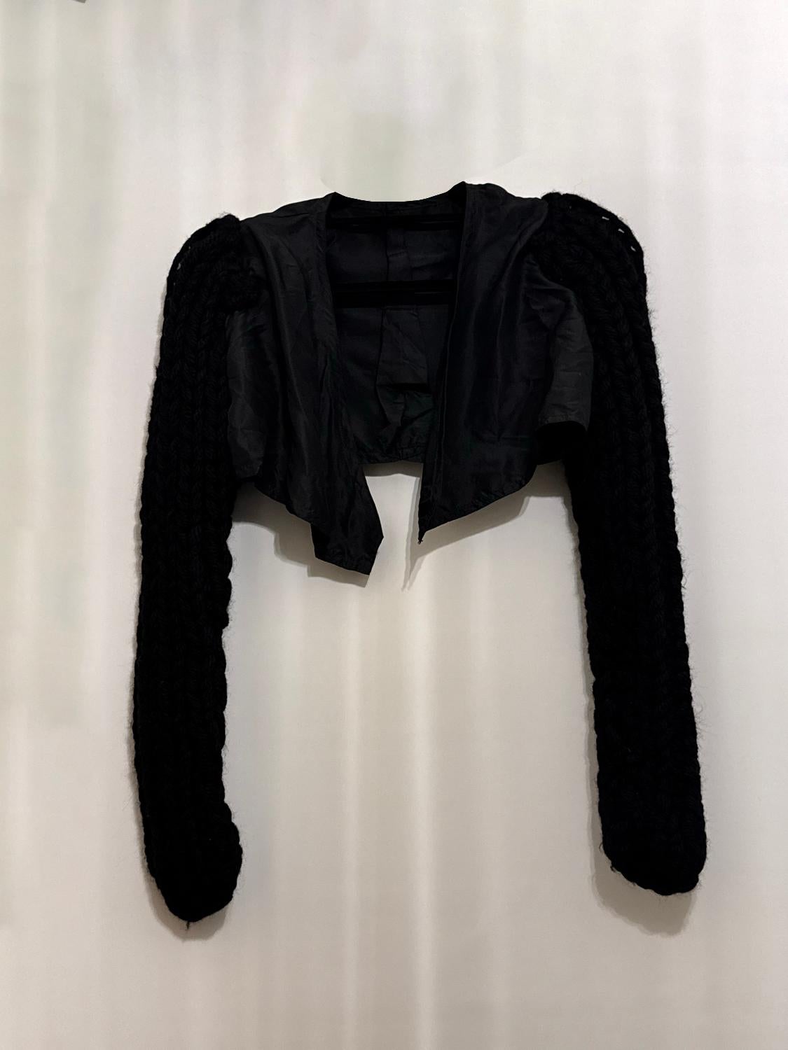 An interesting vintage item, a shrug with wonderful knitted sleaves. The sleaves have a nice knit and fastenings could be added.
Measurements: Shoulder to Shoulder 13'', length 11 1 /2''