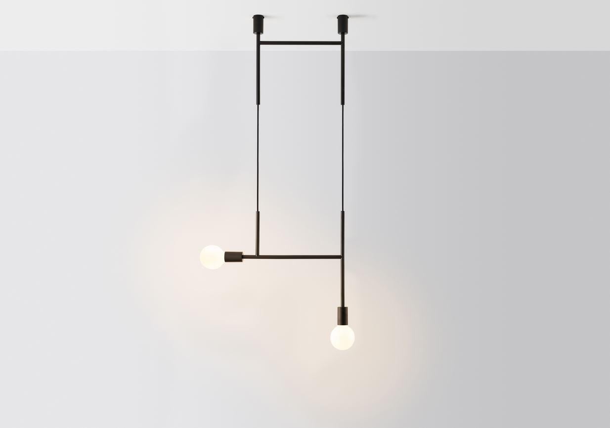 Black side kick by Volker Haug
Dimensions: W 63.2 x H min 108 cm
Materials: Polished, bronzed brass or steel
Cord: Fabric or metal
Finish: Raw, satin lacquer or powdercoat
Weight: approx 2.3 kg

Lamp: 240V E27 (120V E26 US) 
Custom finishes