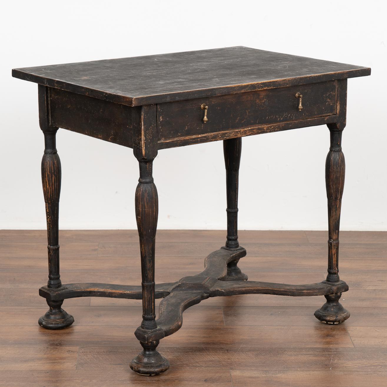 This delightful side table is a wonderful example of Swedish country craftsmanship of the early 1800's. The turned legs with X stretcher base resting on bun feet are traditional style elements while a single drawer with double pulls adds function as