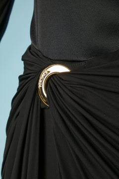 Black silk and jersey evening gown with embroideries on the sleeves Versace