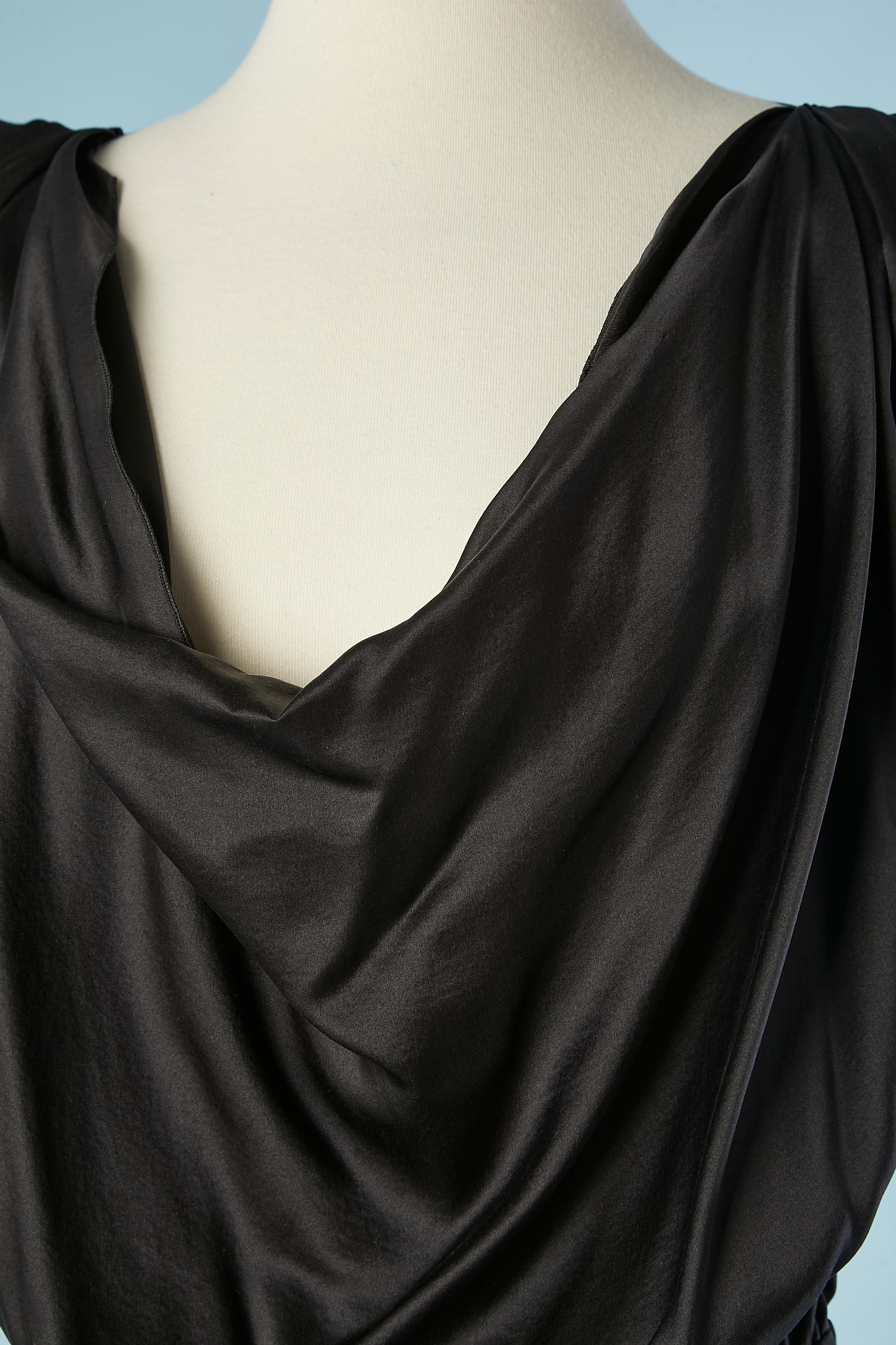 Black silk and rayon cocktail dress. Draped on the bust. Double lays of fabric on the skirt, the top part is shorter in the front and raw cut with ruffles. Zip on the left. no lining. Elastic band on the waist. 
Fabric composition: 30% silk, 70%