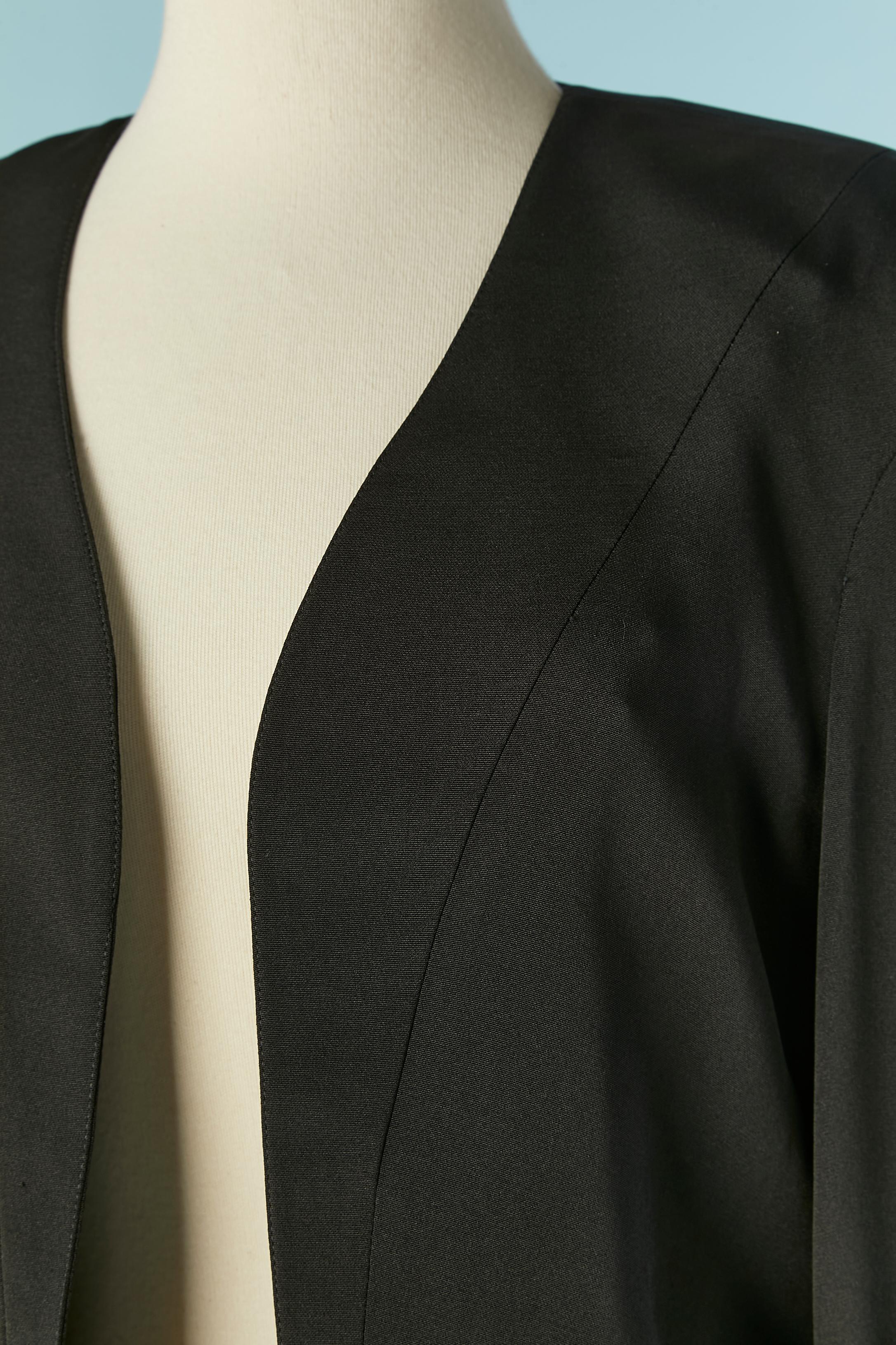 Black silk and wool asymmetrical boléro. Fabric composition: 60% silk, 40% wool. 
No lining but black satin ribbon piping inside. Shoulder-pad. 2 Snaps on each cuffs. 
SIZE 40 (Fr) M 