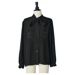 Black silk blouse with tie collar branded on the breast pockets Chanel Boutique 