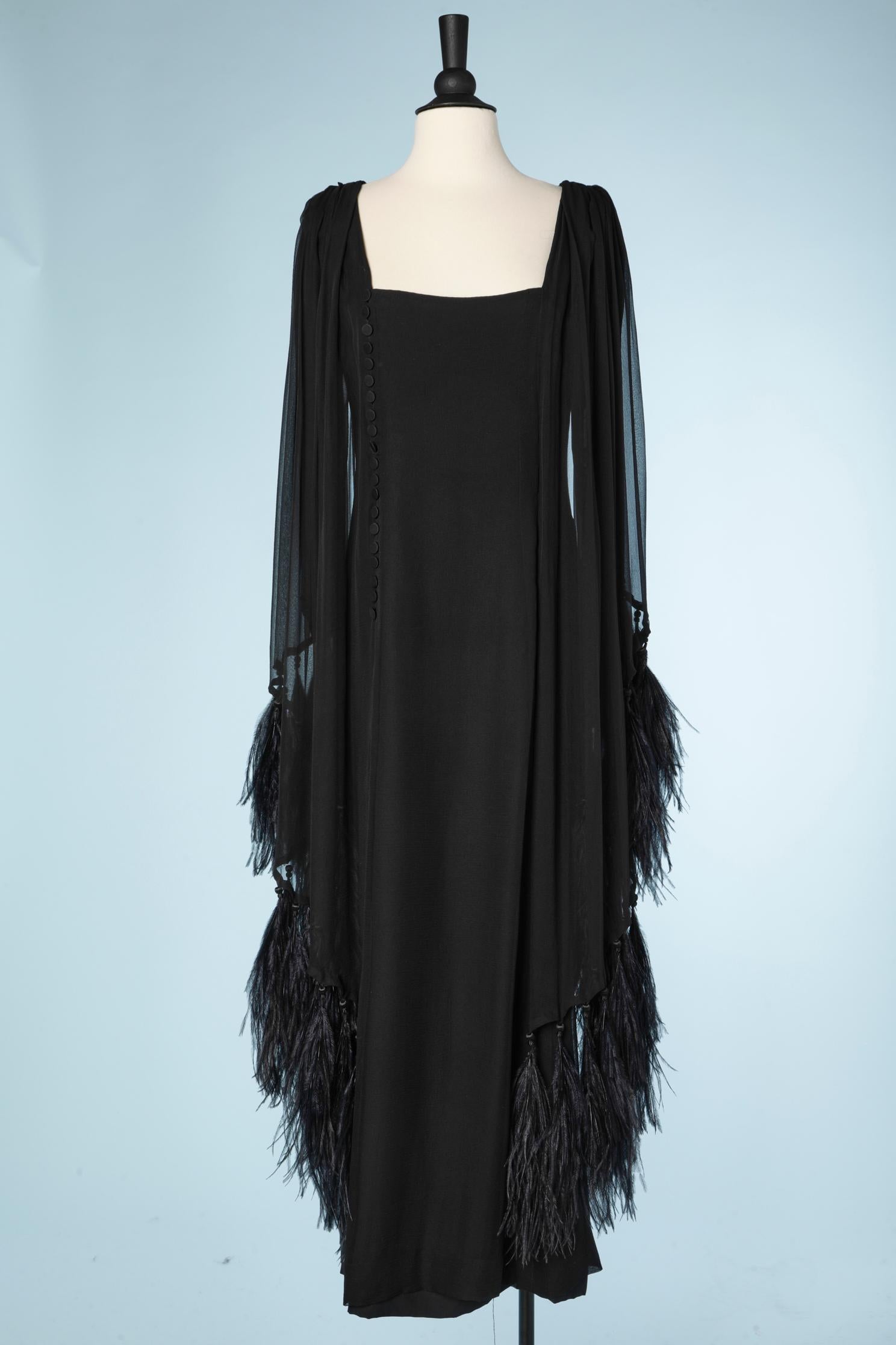 Black silk chiffon evening dress with feathers edge. Fabric bottons and zip ( under the button placket) Fabric  Buttons at the end of the sleeves. A small ball of trimming is attached to each strand of feathers. 
SIZE L 
Please note that the dress