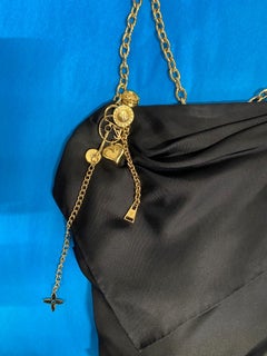 Black silk cocktail dress with gold metal chain and pendants Louis Vuitton