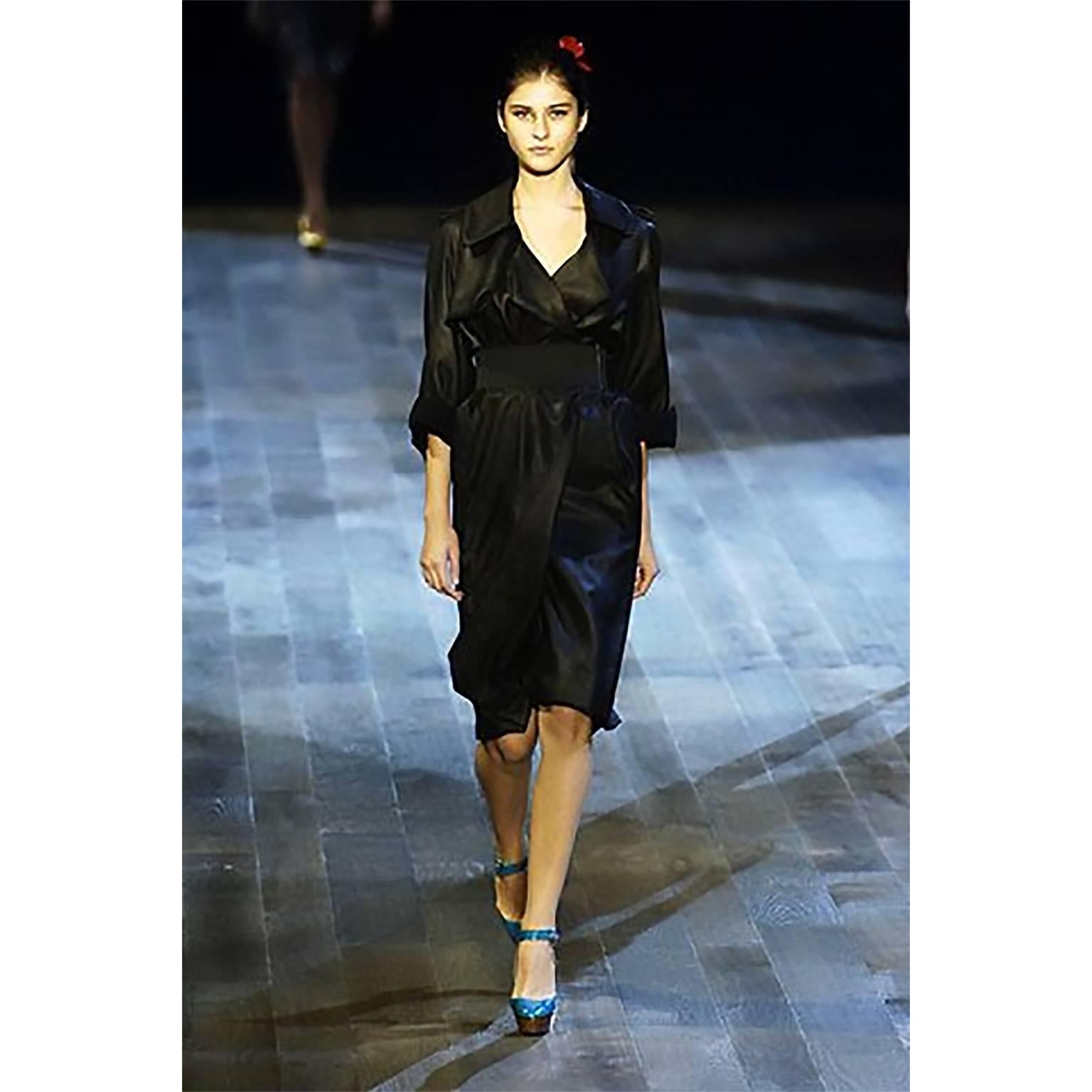 We are in love with this sublime black pure silk trench coat from Lanvin is perfect for Summer and Fall! This lightweight coat is from the Lanvin Spring Summer 2006 collection and if belted with a wide belt, as shown in the photograph of it being