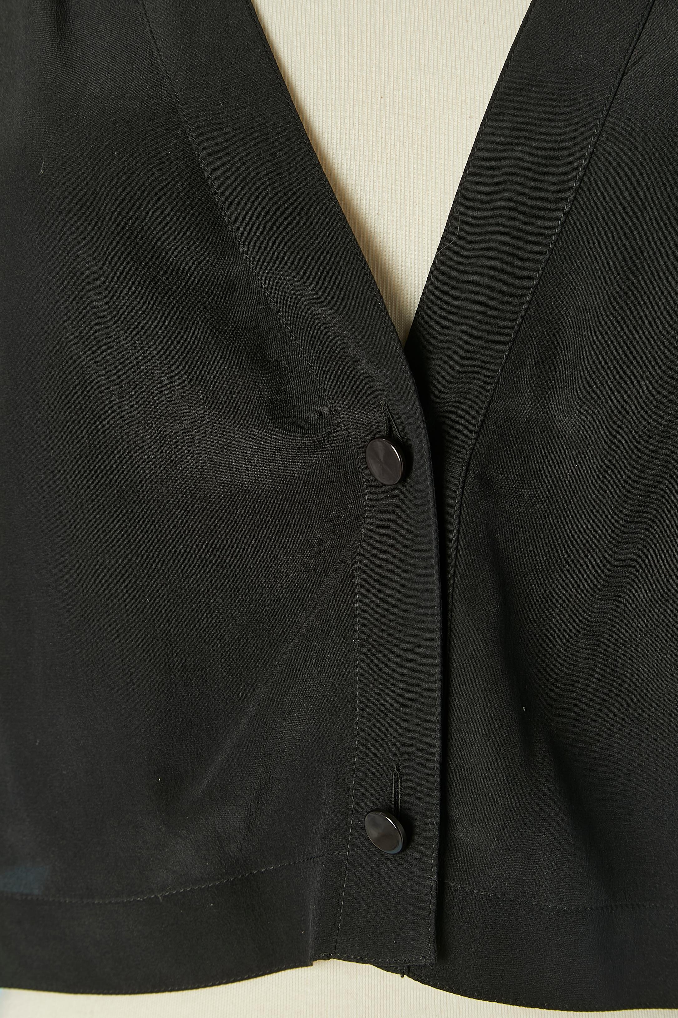 Black silk shirt with large shoulder-pad. Button and buttonhole closure on the middle front. 
Could be design by K Lagerfeld for Chloé 
SIZE 44 (It) 40 (Fr) L 
