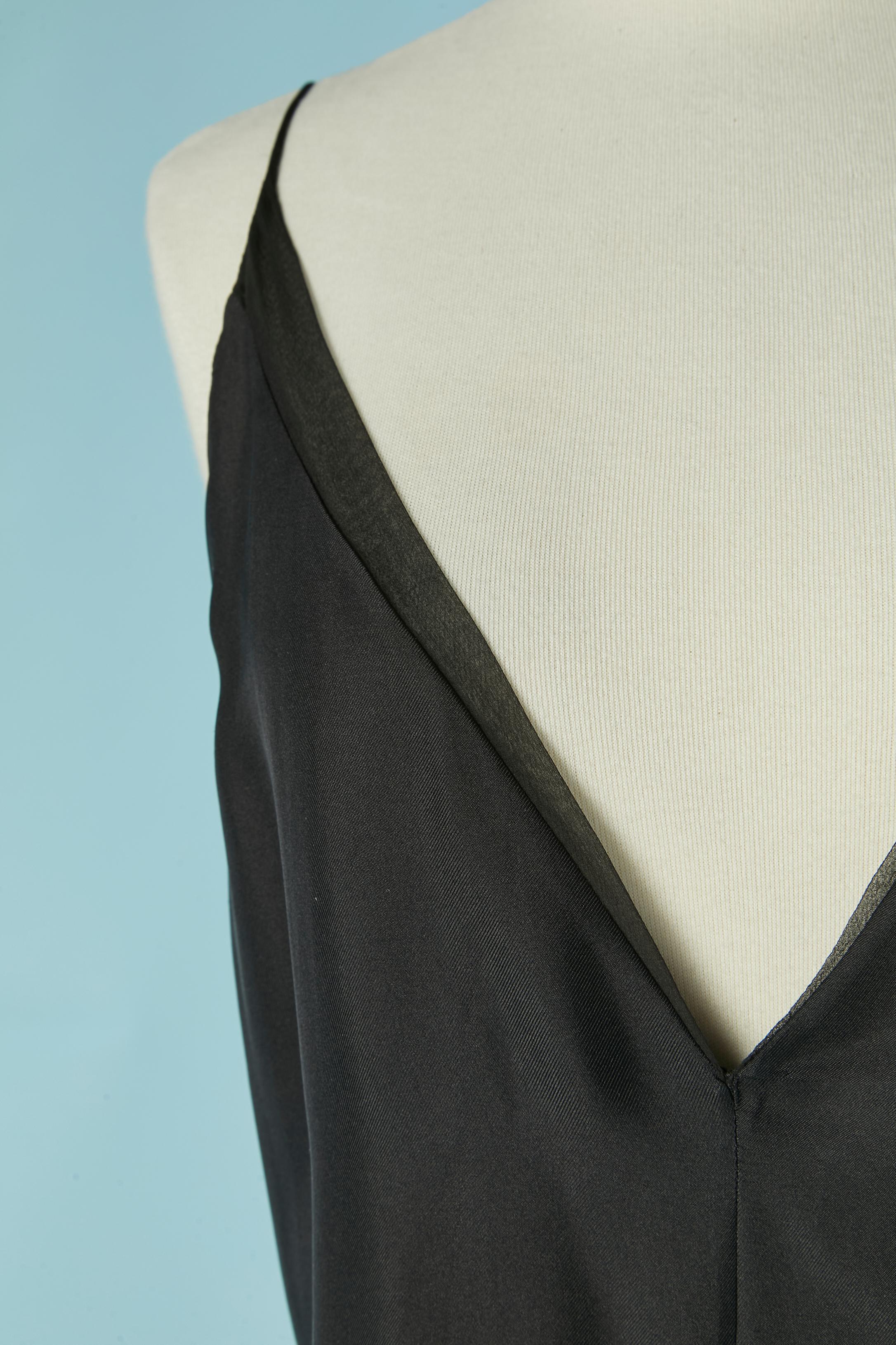 Tuta corta in seta nera. Chiffon di seta sul bordo superiore e sul bordo inferiore. Chiusura con zip e gancio sul lato sinistro. 
TAGLIA M/L 