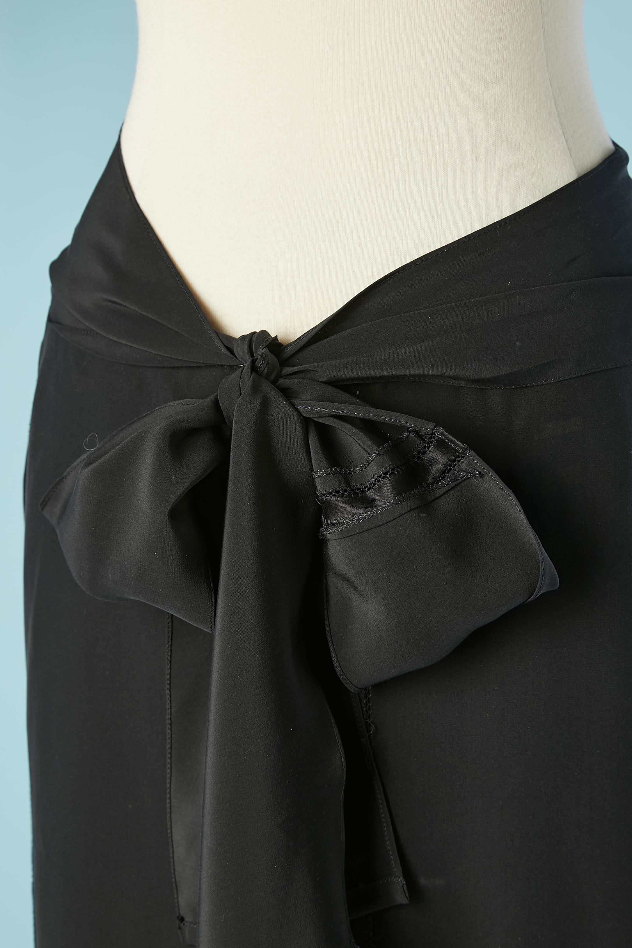 Black silk skirt with see-through opening and belt. 
Snap closure on the left side. 
SIZE L 