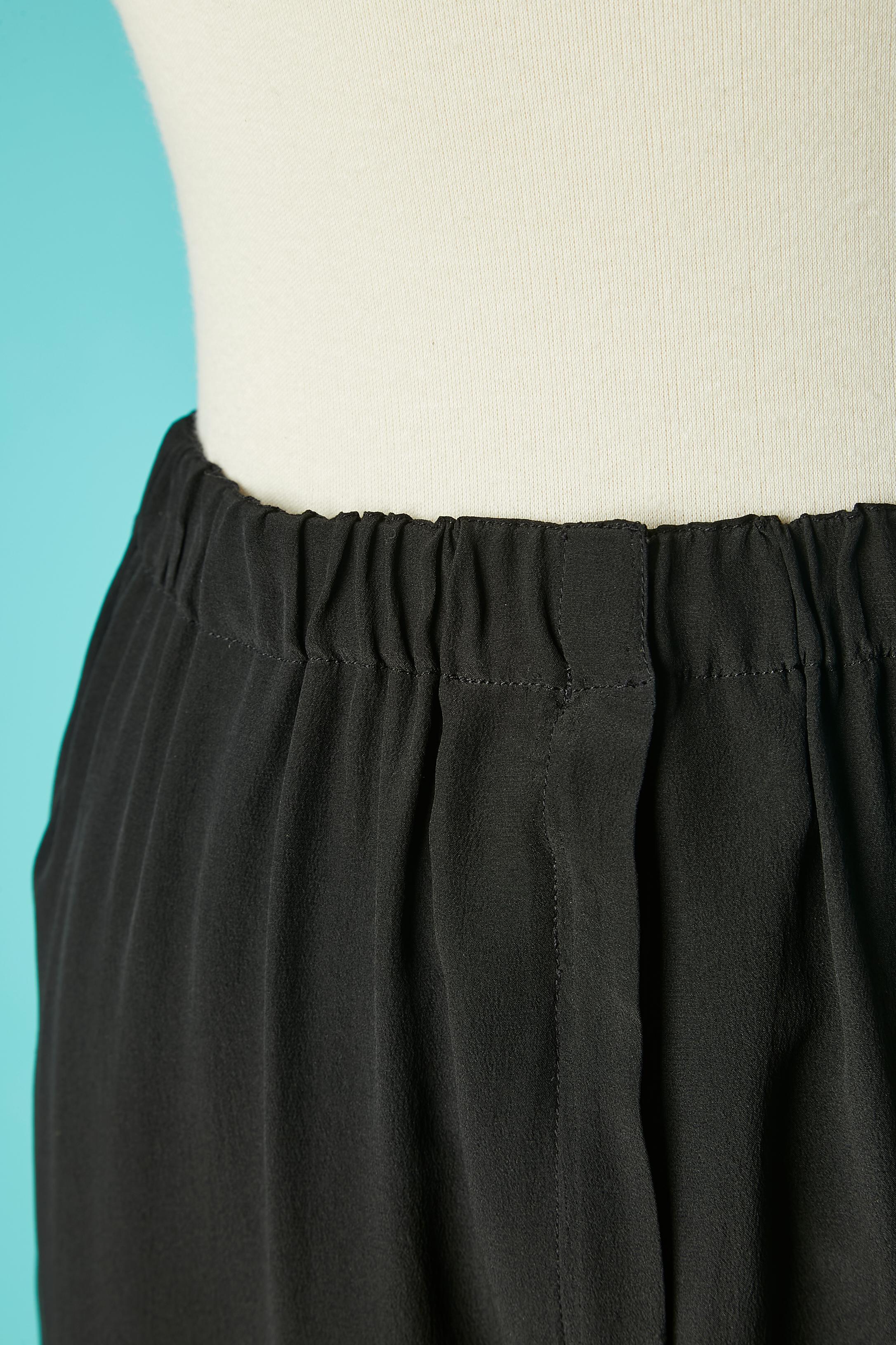 Black silk trouser with 2 hook&eye and zip closure on the middle front. Elastic waist band. 3 buttons and buttonhole on the bottom side of each legs. 
SIZE S 
