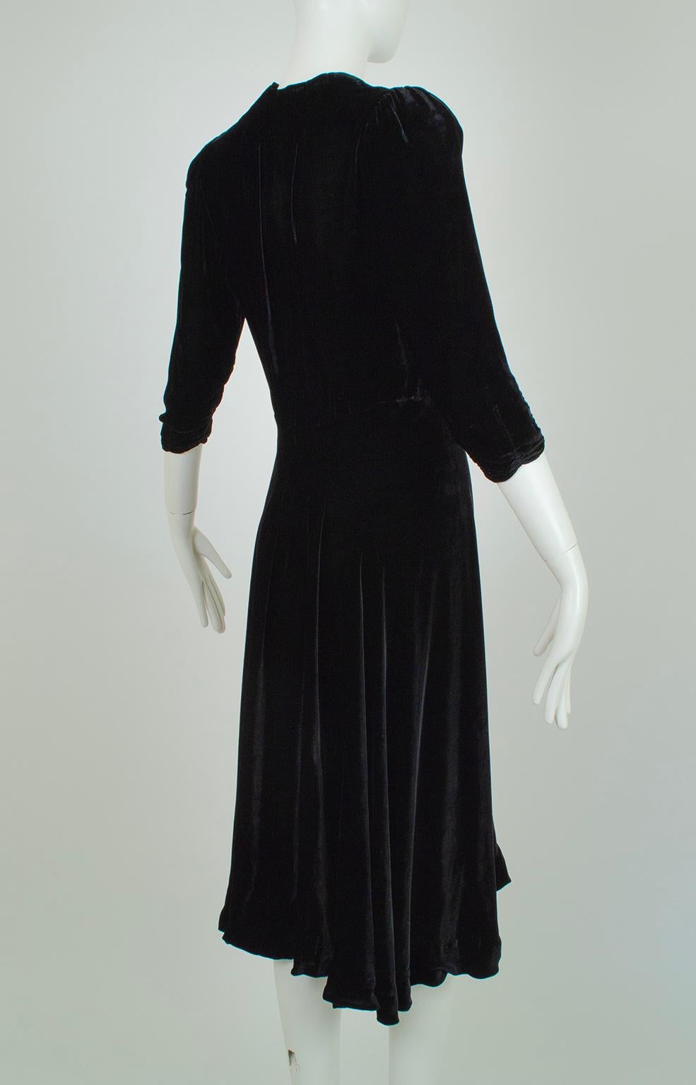 A dress Barbara Stanwyck might have worn alongside Fred MacMurray, this swirling dress reeks of the double-crossing Femme Fatale. The alluring plunge neckline, body-skimming flare skirt and sumptuous silk velvet fabric beg for attention, while its