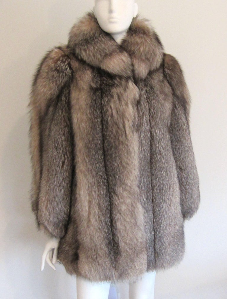 Stunning soft supple Fox fur Jacket. Clip closure high on the neck to keep you toasty warm along with 2 more hidden clip closures. 2 slit pockets. French hem on lining. Monogrammed inside (see photo's ) Arm holes are small for that extra warmth.