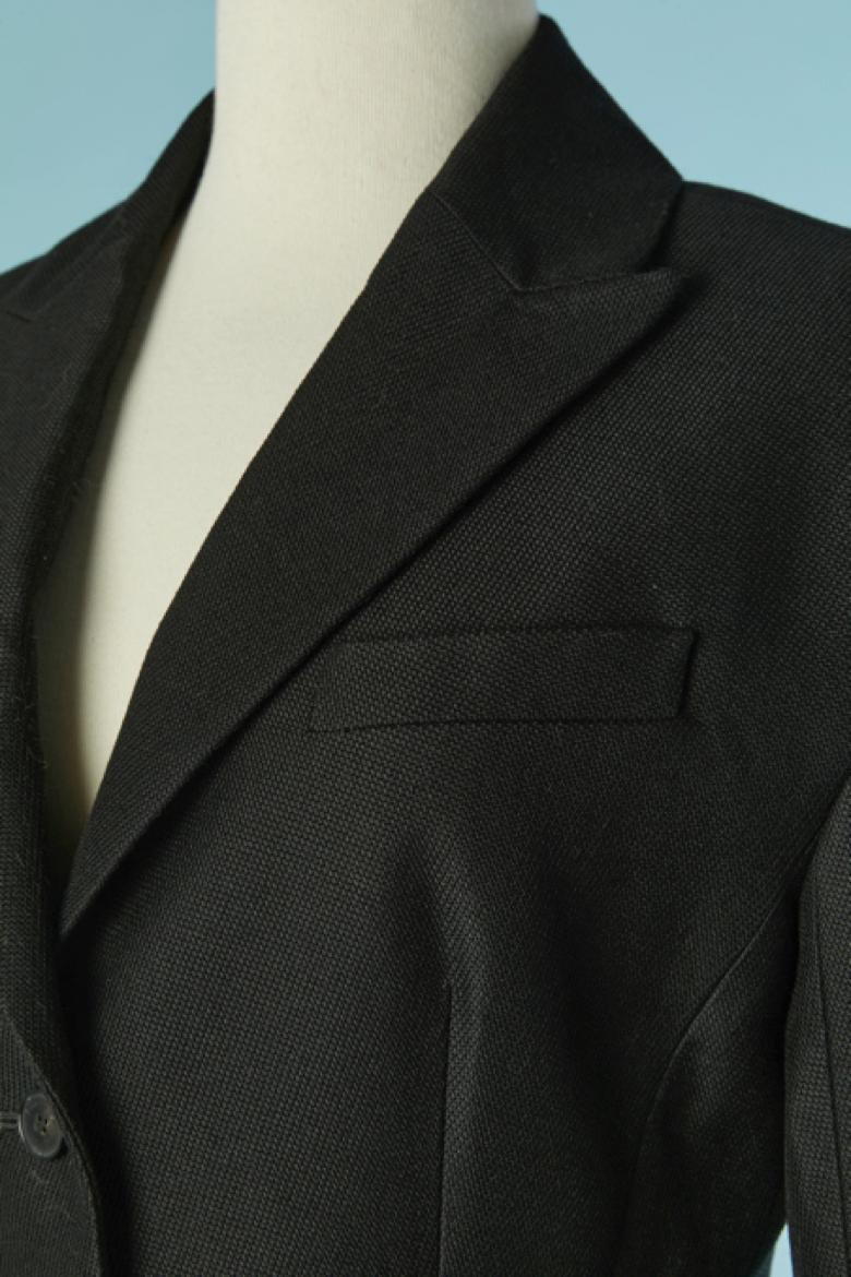 Black single breasted BAR jacket. No fabric composition tag but probably wool and rayon lining. 3 pockets on the front. Branded button and buttonhole closure on the middle front and on the cuffs. 
Split on the middle back, lenght= 20cm
Shoulder