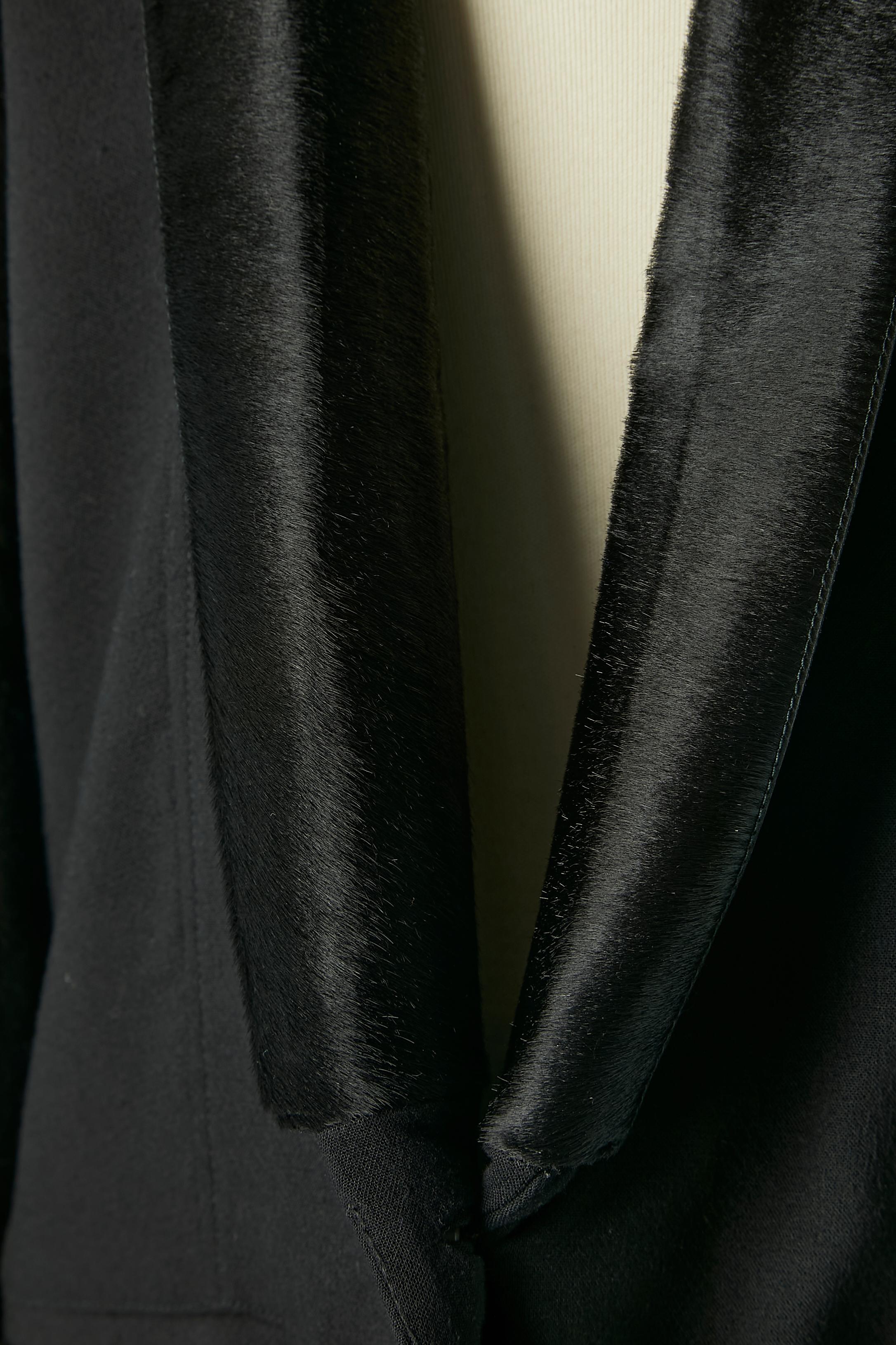 Black single breasted tuxedo jacket with black fur collar. Shell composition: 62% rayon, 34% wool, 4% elasthane. 
Lining: 95% polyester, 5% spandex. 
Fur: dyed calf 
2 extra buttons provided. Split middle back= 18 cm 
Size 2 on tag but fit 38 (Fr) M