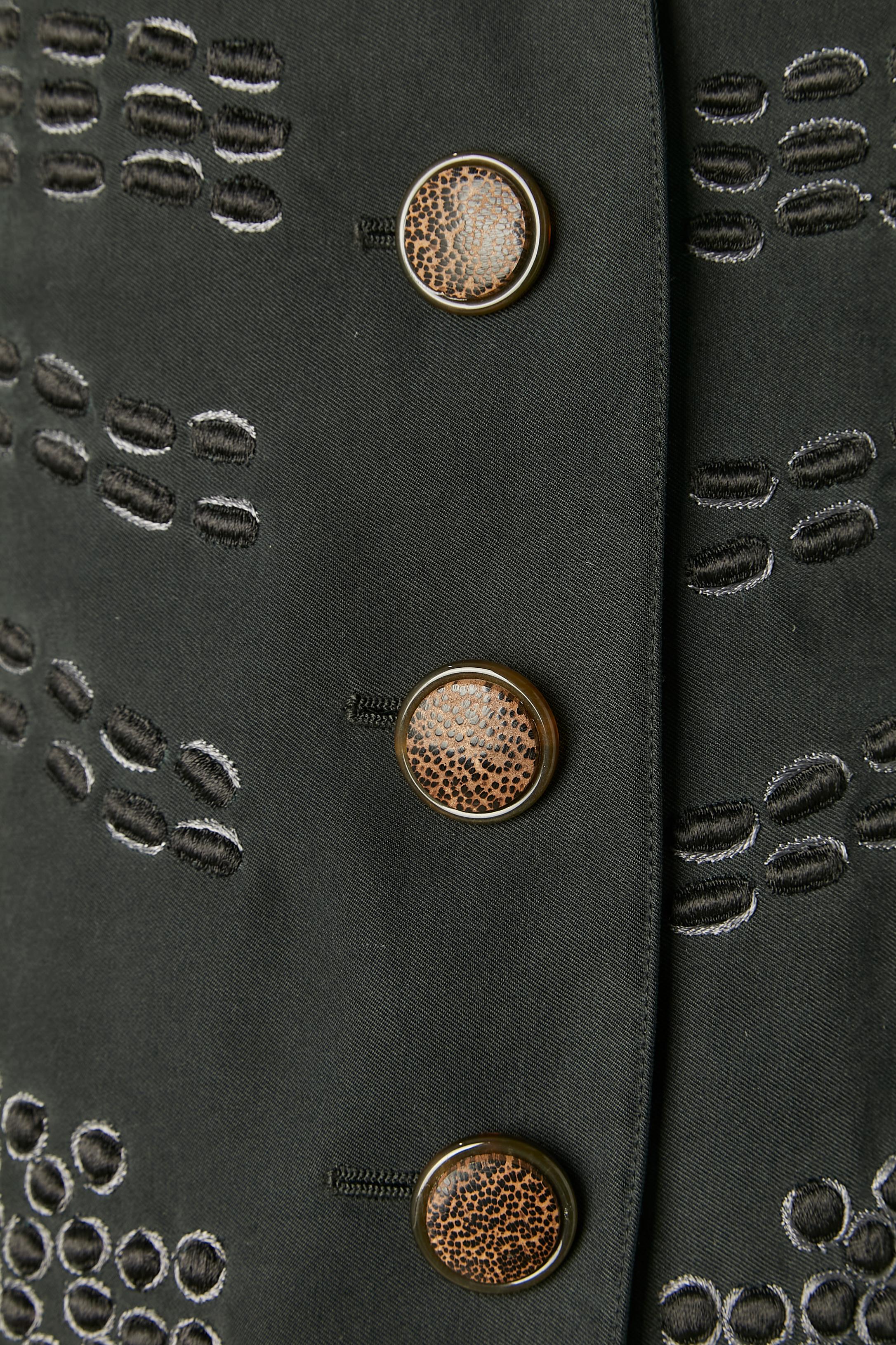 Black skirt suit with black and grey threads embroideries. No fabric composition tag but the main fabric is probably cotton and silk and the branded lining is probably silk. Shoulder-pad. 
SIZE 12 (Us) L 