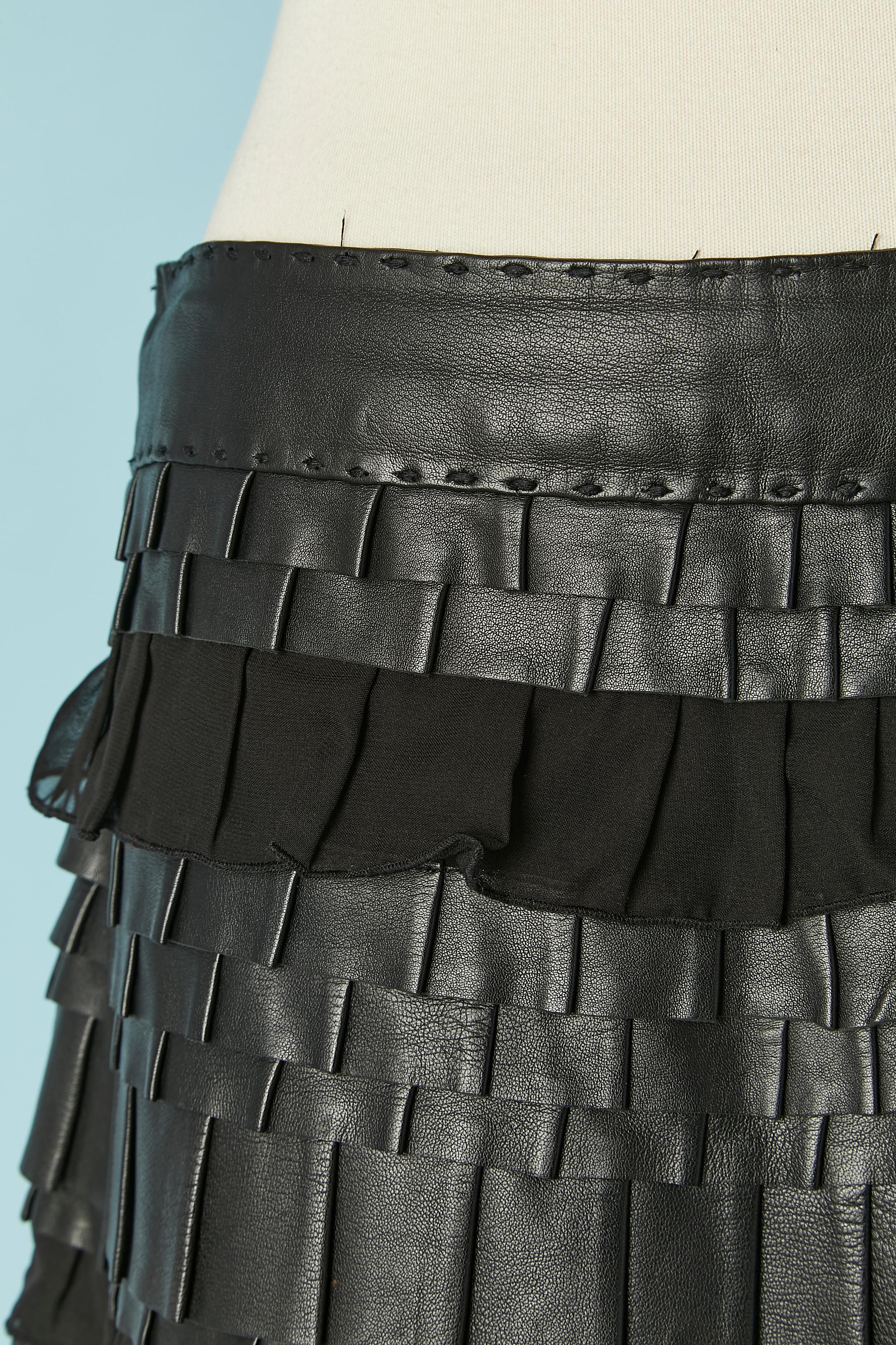 Black skirt with leather and chiffon ( polyester) ruffles. Zip and hook&eye on the left side. Acetate or rayon lining. 
SIZE 42 (It) 8 (US) M 