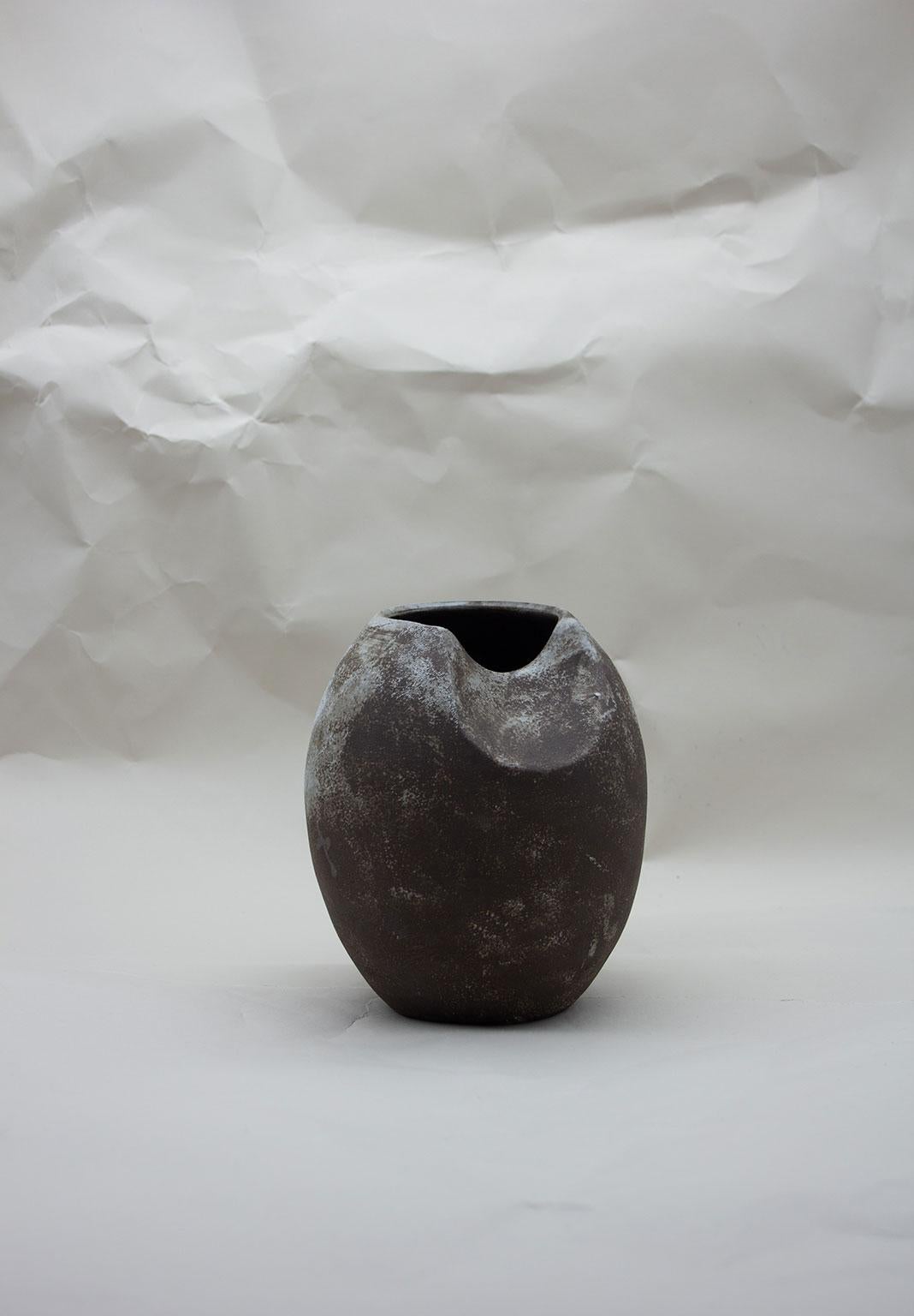 The Black Sliced Sphere blurs the boundary between a functional vase and a sculptural object. Created as part of the Soft, Soft Hard 2018 Collection, this pieces is an exploration into form and the relationship between the wheel and hand building,