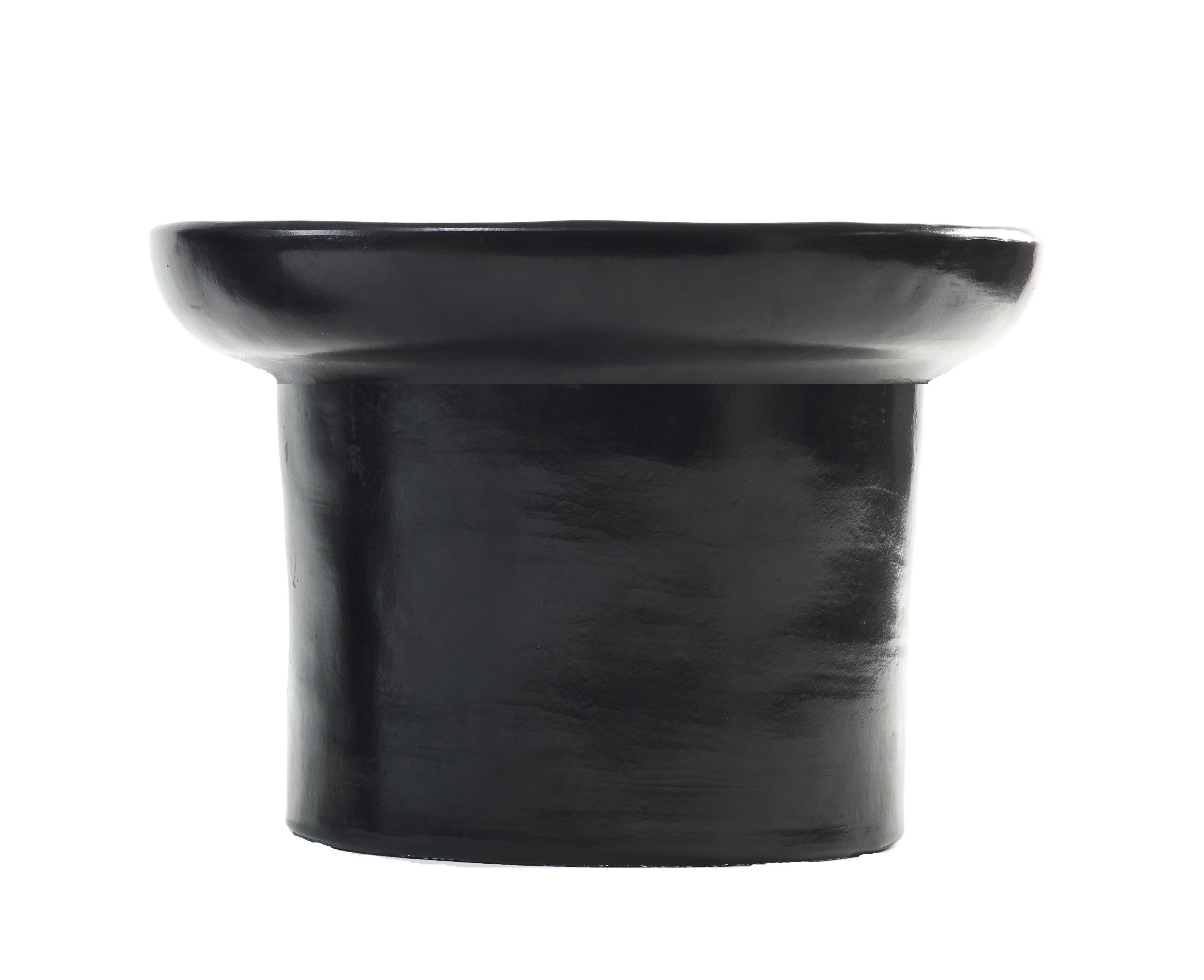 Black small nuna side table by Sebastian Herkner
Materials: Heat-resistant black and red ceramic. 
Technique: Glazed. Oven cooked and polished with semi-precious stones.
Dimensions: Diameter 42 cm x height 23 cm 
Available in colors red, and