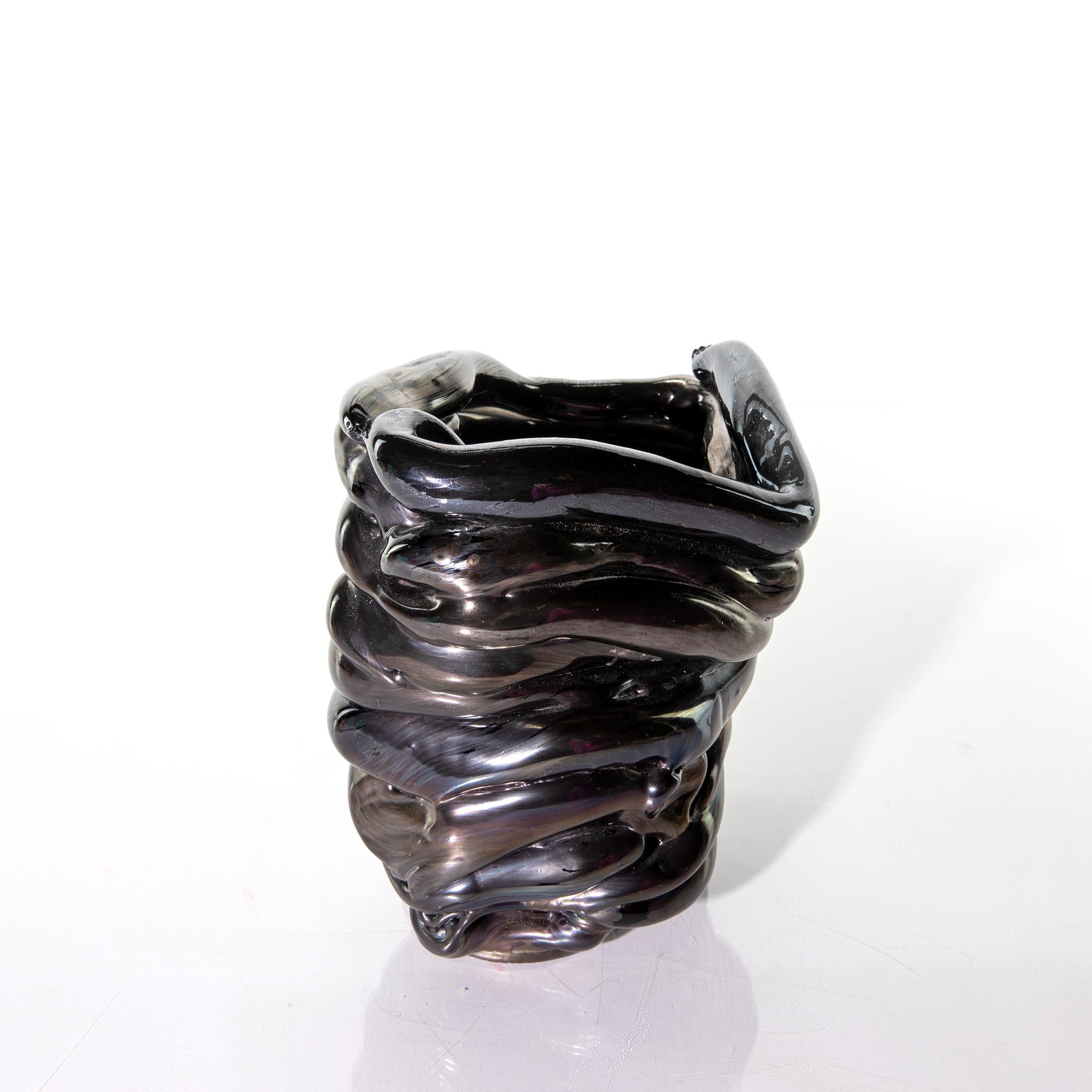 Made of black iridescent glass, this solid sculpted coil vase was made by Romina Gonzales in 2014. Due to the nature of the making process, this sculpture is not water tight. 