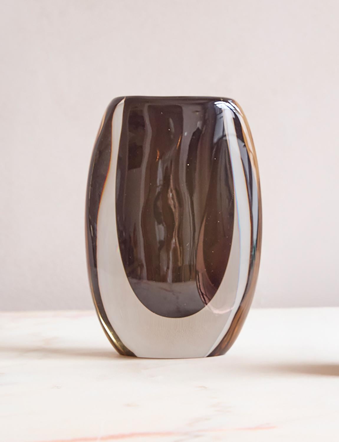 A 'Cenedese' black and transparent sommerso vase (submerged glass) hand-blown in Murano, Venice in the 1960s. This tall vase is very heavy due to the wonderful thickness of the glass. It has a black/brown core and transparent surround. It makes for