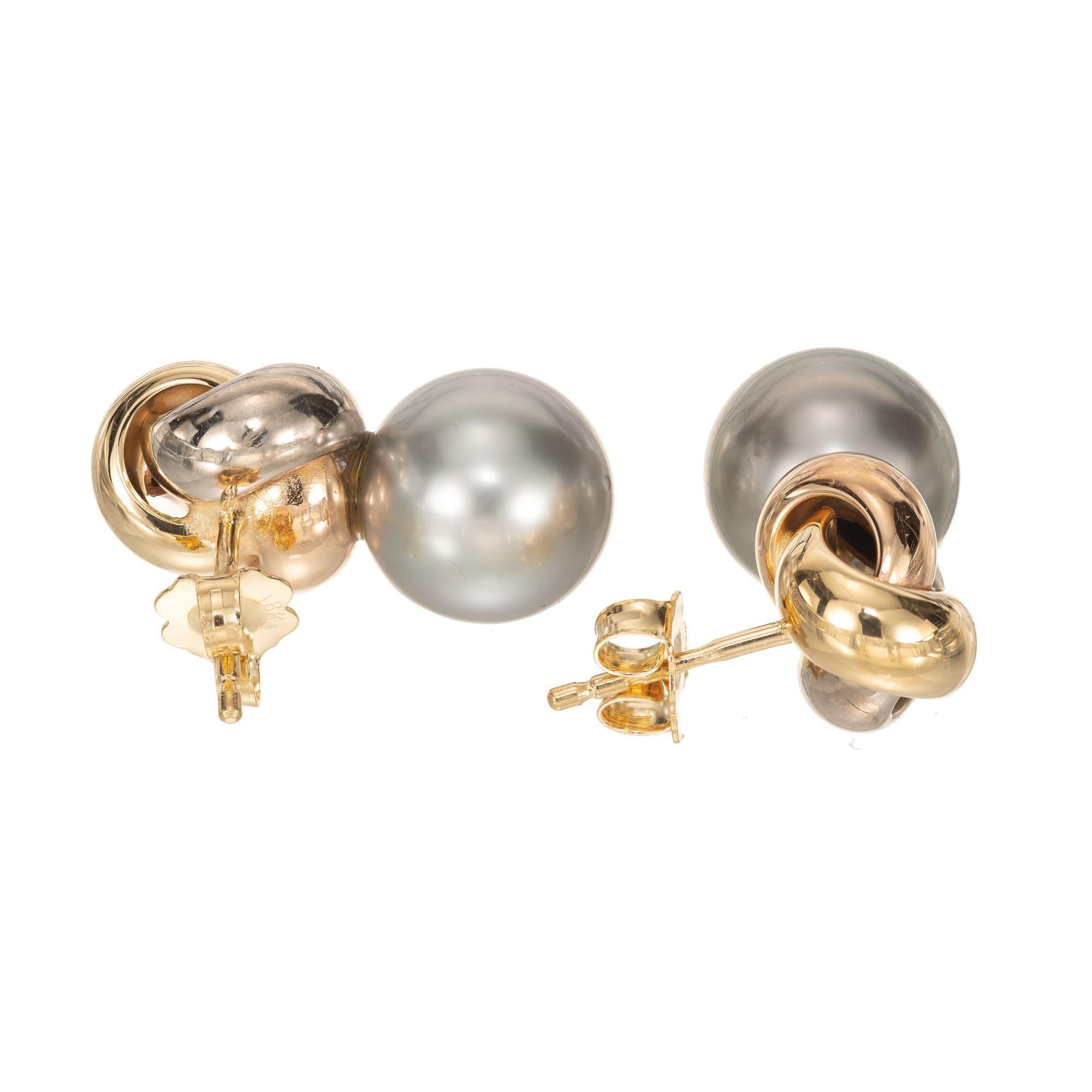 18k tri-color gold knot earrings in yellow, rose and white gold with a 10mm black South Sea Cultured Pearl set below. 

2 10mm South Sea cultured Pearls
6.9 grams
Tested: 18k
Stamped: 750
Hallmark: HS
Top to bottom: 20.04mm or .79 inch
Width: