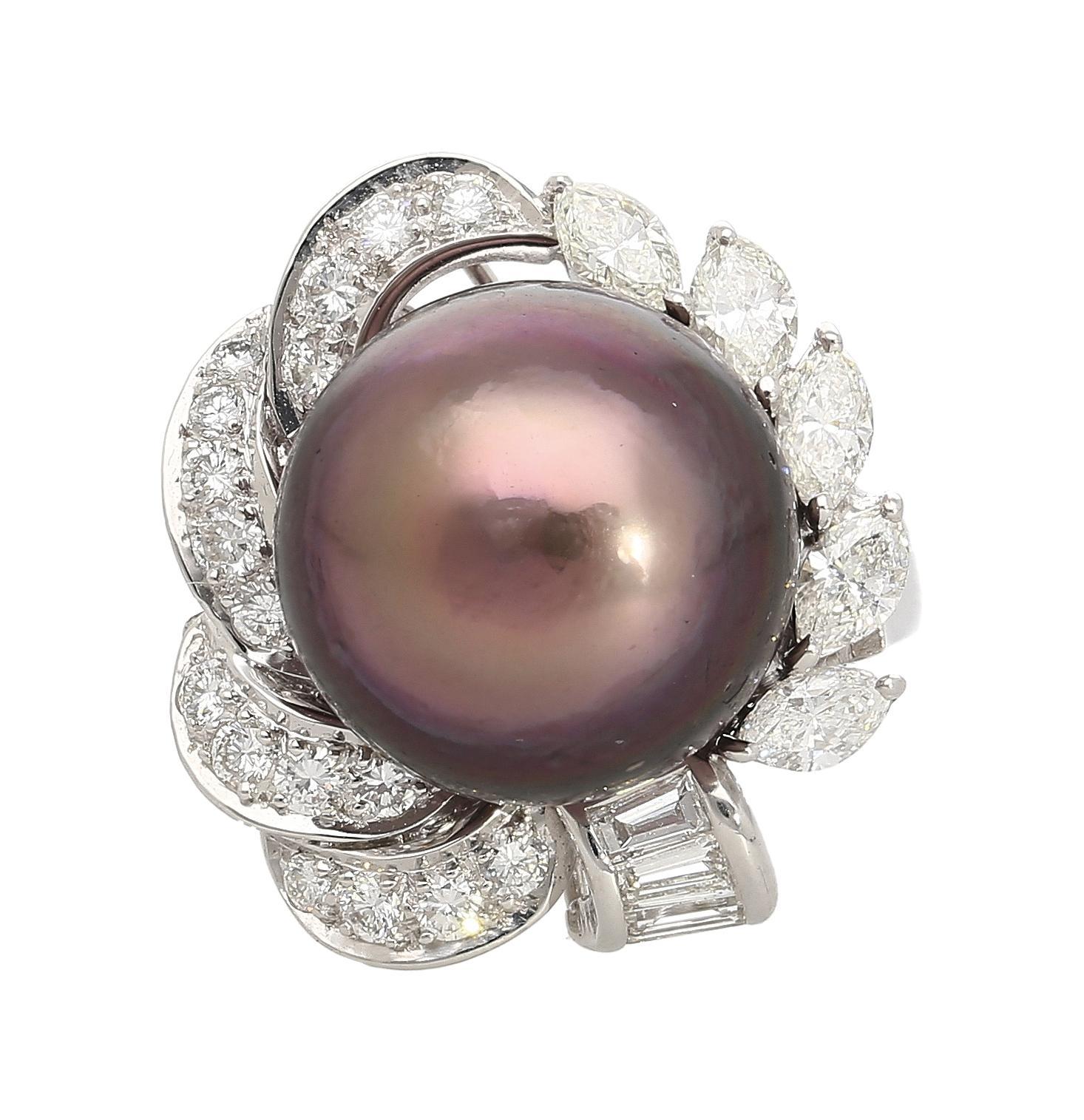 A radiant black south sea pearl sits at the heart of this 18K white gold statement ring, accented with 1.41 carats of diamonds in a dramatic cluster design. The split shank adds an elegant finishing touch. Ring size 6.25, adjustable. 

Details:
Item