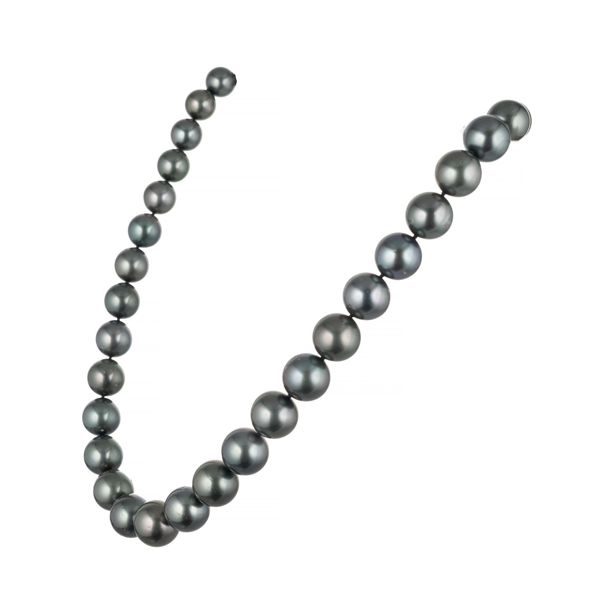 18 Inch strand of black cultured pearls graduating in size from 10mm to 13.25mm attached by a corrugated 10mm 14k white gold ball lock. High lustre few blemishes. Well matched.

37 cultured south sea black pearls 10-13.25mm
14k white gold 
Stamped:
