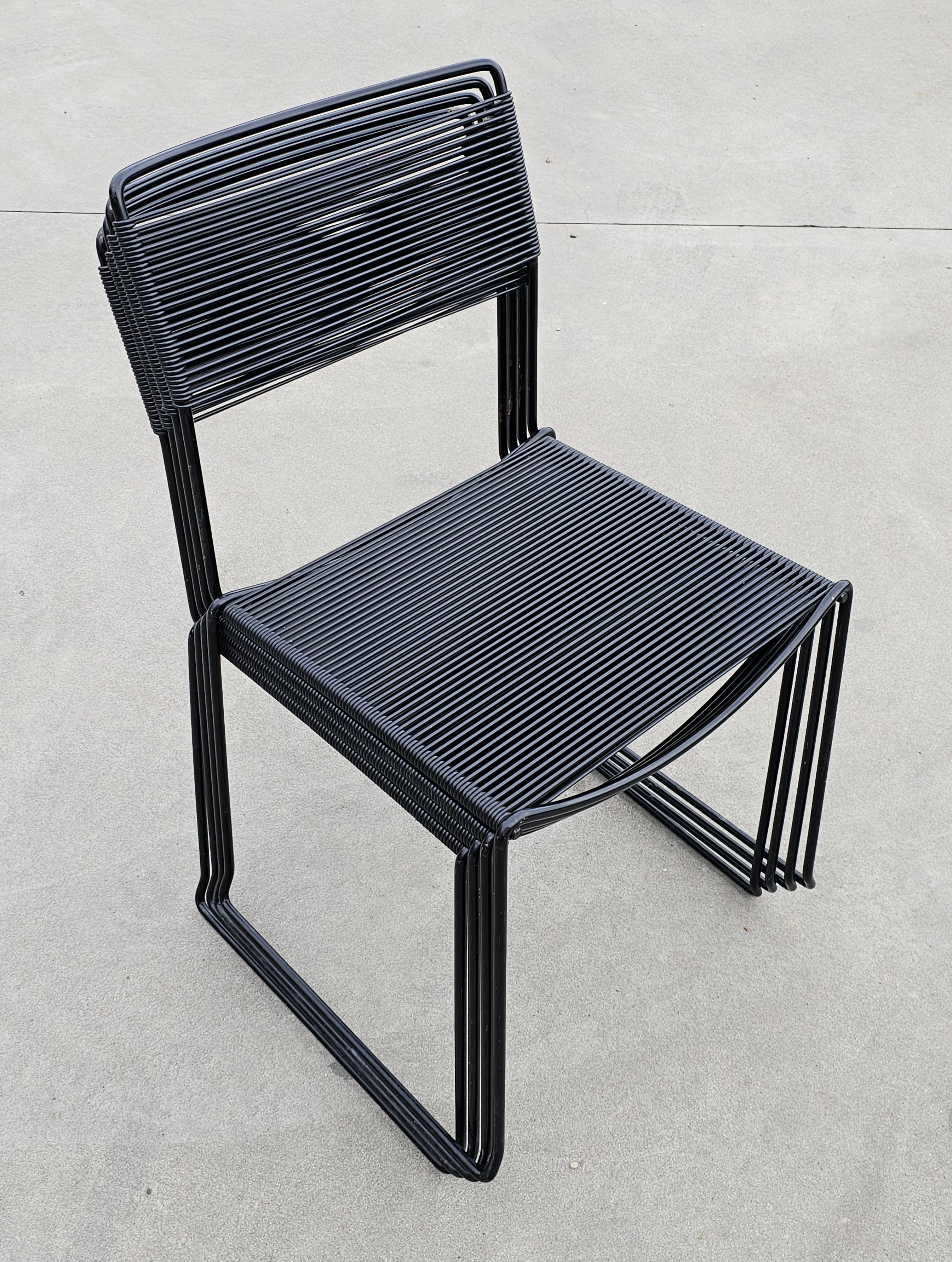 In this listing you will find 4 postmodern black dining chairs called Spaghetti, due to their PVC threaded seats and backrests. The chairs were designed by Giandomenico Belotti for Alias in 1970s.

Good vintage condition with some signs of time and