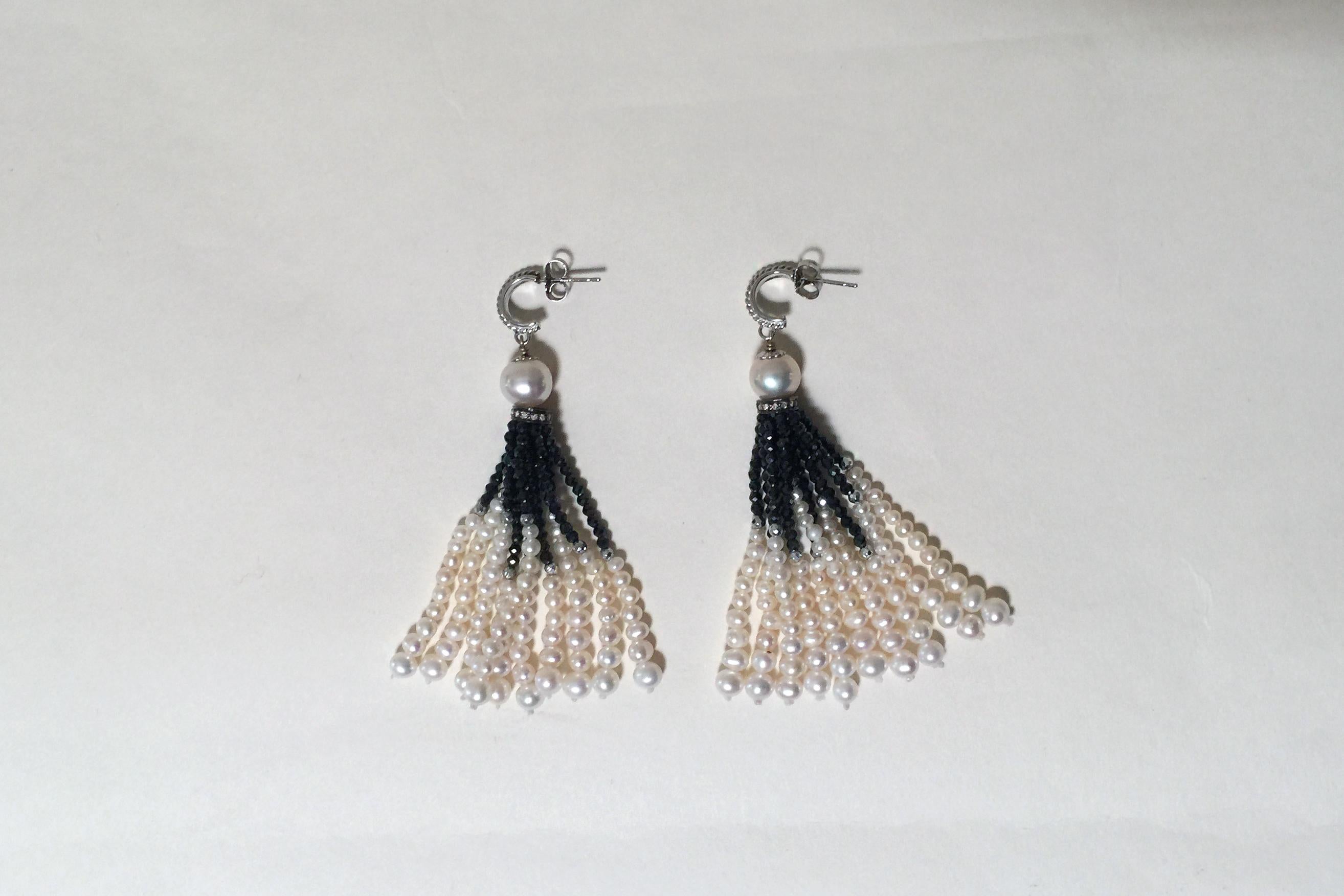These black spinel and white pearl tassel earrings with 14k white gold stud and sterling silver findings are elegant. The graduated strands of the tassel start with glittering black spinel and finish with glowing white pearls. In between the spinel