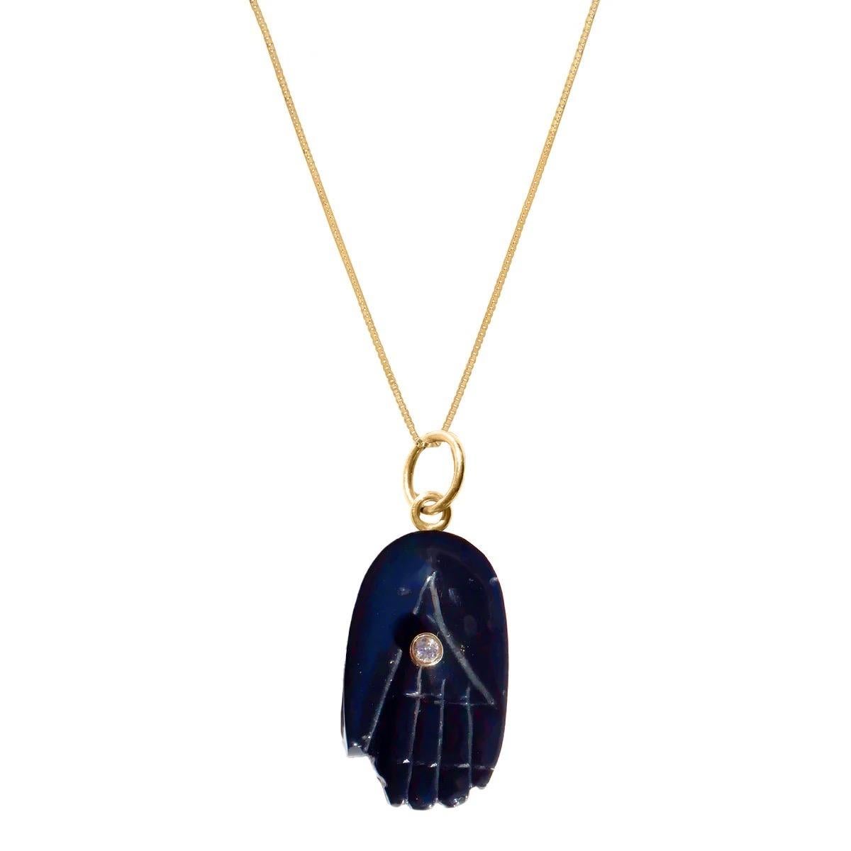 Black Spinel Diamond Gold Hamsa Pendant. Peace and Protection for all with the universal symbol of the Hamsa featuring a pendant in glossy natural black spinel with a center gold encased diamond 'eye’.

- Black Spinel apprx 35 carats.
- Set with an