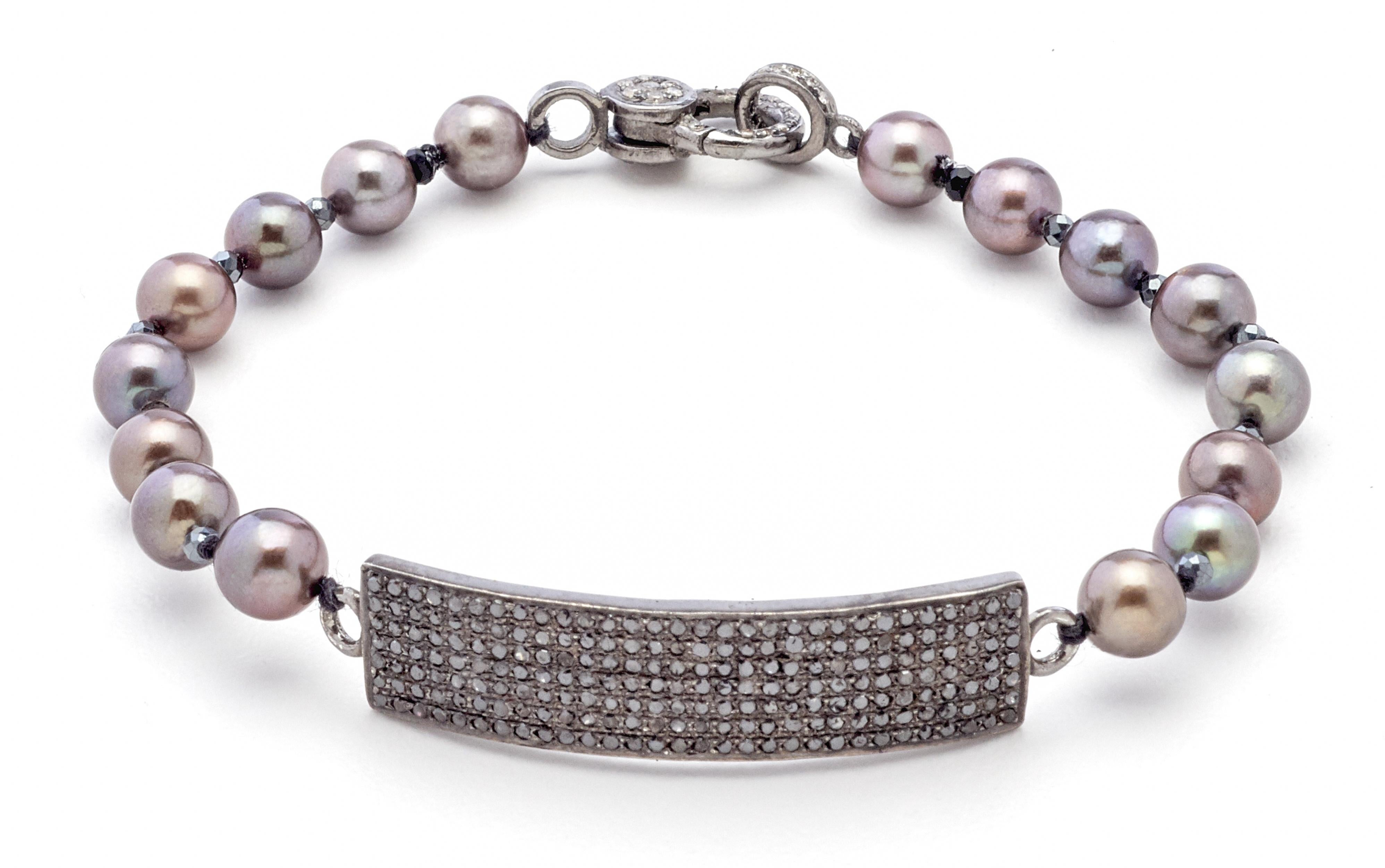 Sparkling black spinel glistens in an attractive rectangular shape silver bar feature lending a modern twist to this artisan created slate-toned pearl bracelet. You will love the versatile dark neutral hues of this seven inch hand- strung 6mm akoya