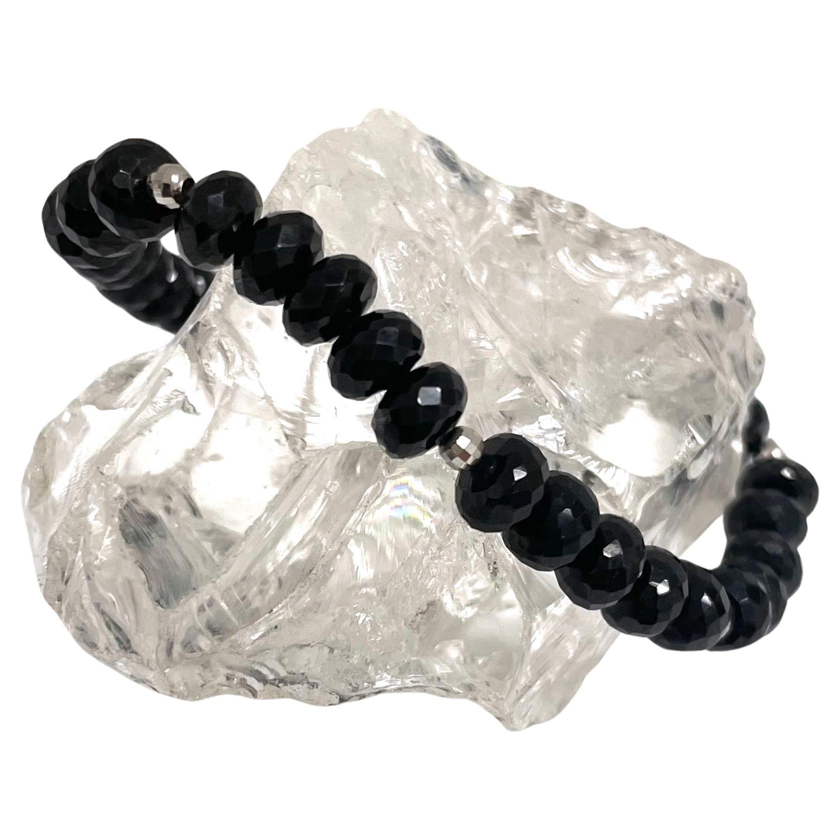 Description
Beautiful, casual or dressy, sparkling black spinel stretchy bracelet accented with 14k white gold faceted balls.
Item # B1320 
Stack it with Item # B1321, sold separately.

Materials and Weight 
Black spinel 81cts.7mm, faceted rondelle