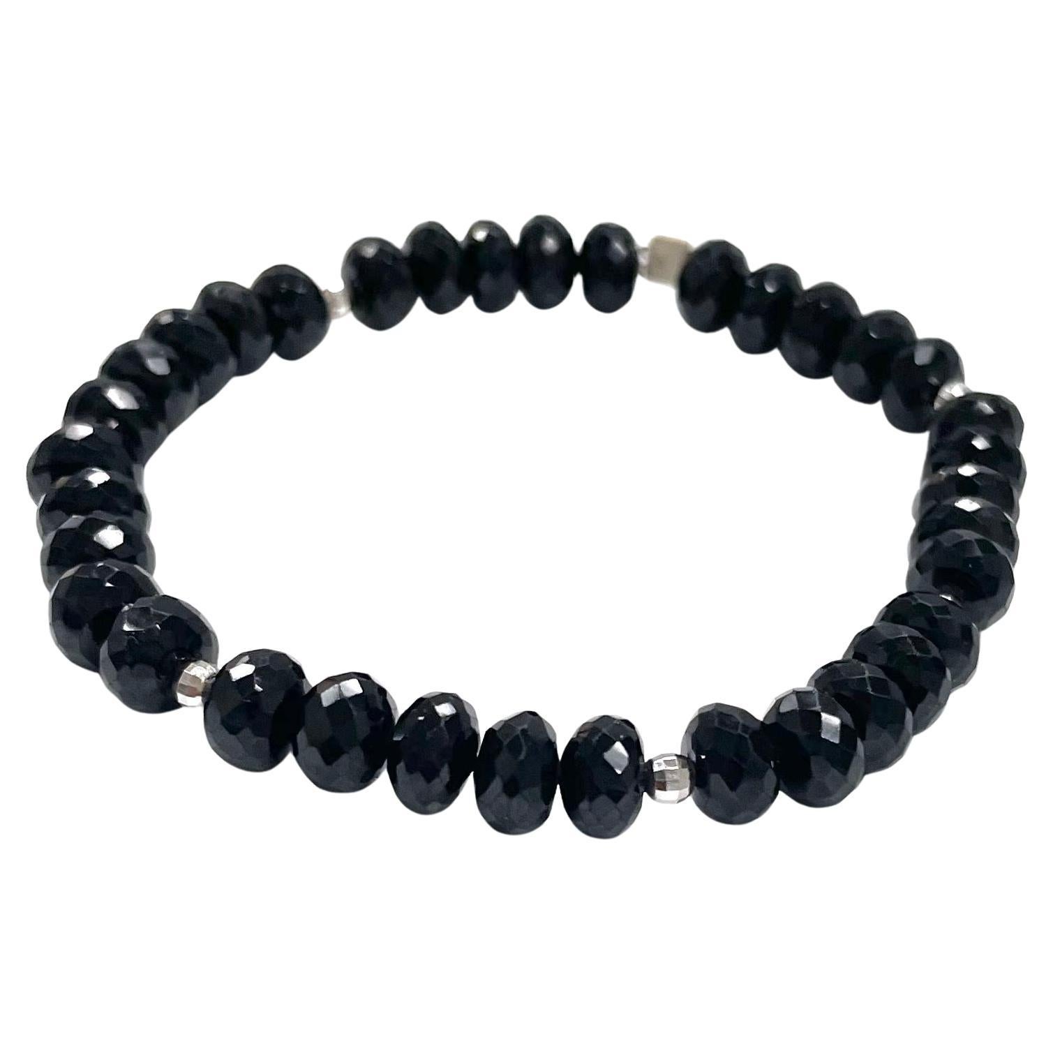 Description
Beautiful, casual or dressy, sparkling black spinel stretchy bracelet accented with 14k white gold faceted balls.
Item # B1321 
Stack it with Item # B1320, sold separately.

Materials and Weight 
Black spinel 81cts.7mm, faceted rondelle