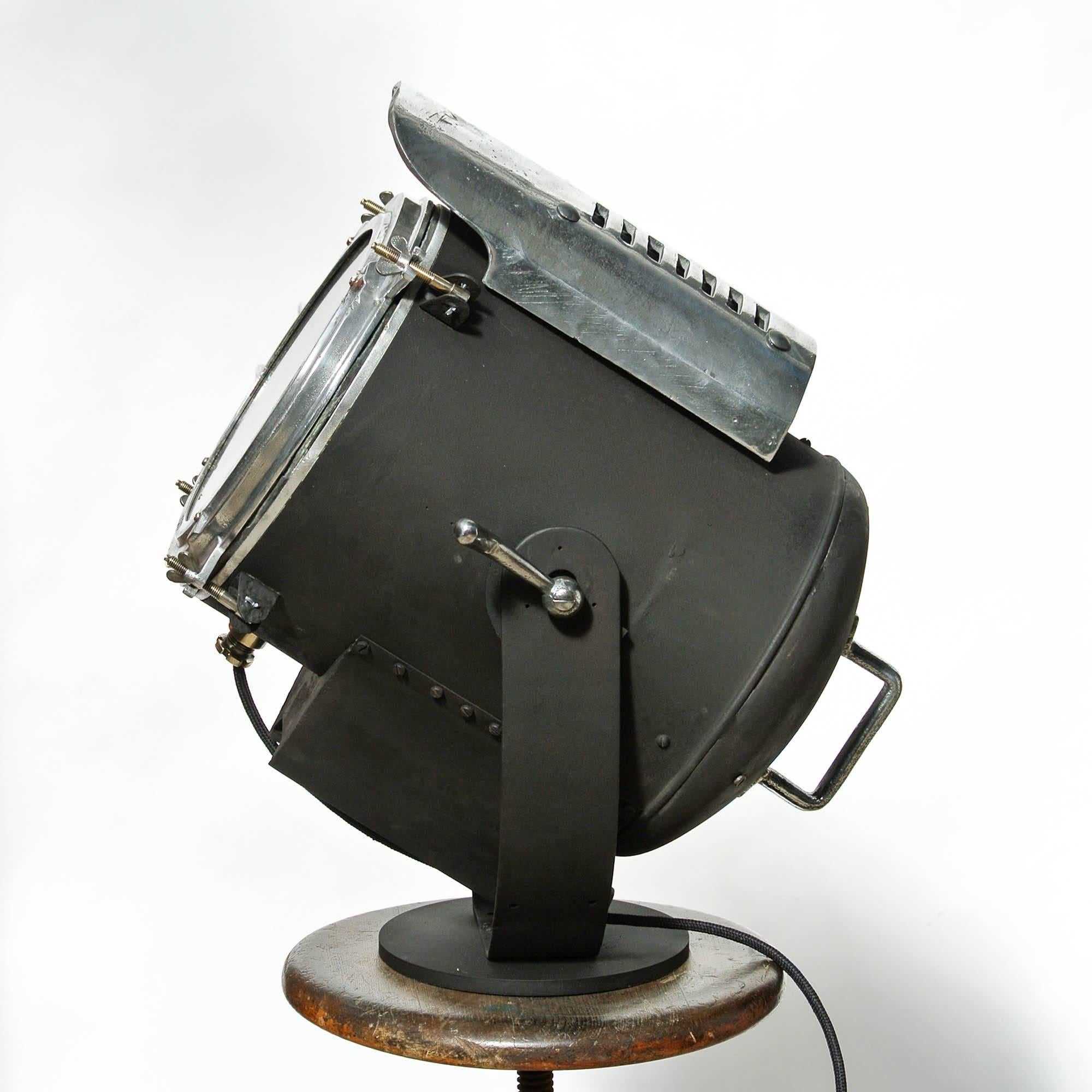 Elegant industrial spotlight from the 1950s, made of steel and die cast aluminium. Spotlight is mounted on an adjustable bracket that focuses the beam as desired. This lamp has been restored: beautiful black painting, polished and re-wired.

 