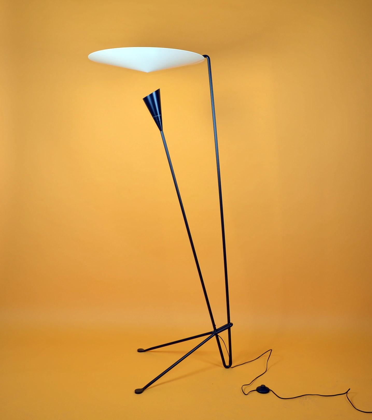 Dynamic lines and an innovative means by which the light is dispersed are signatures of this Michel Buffet lamp. Light shines on the conical disc above from the shade below and is reflected out.

This lamp comes is black and white.

