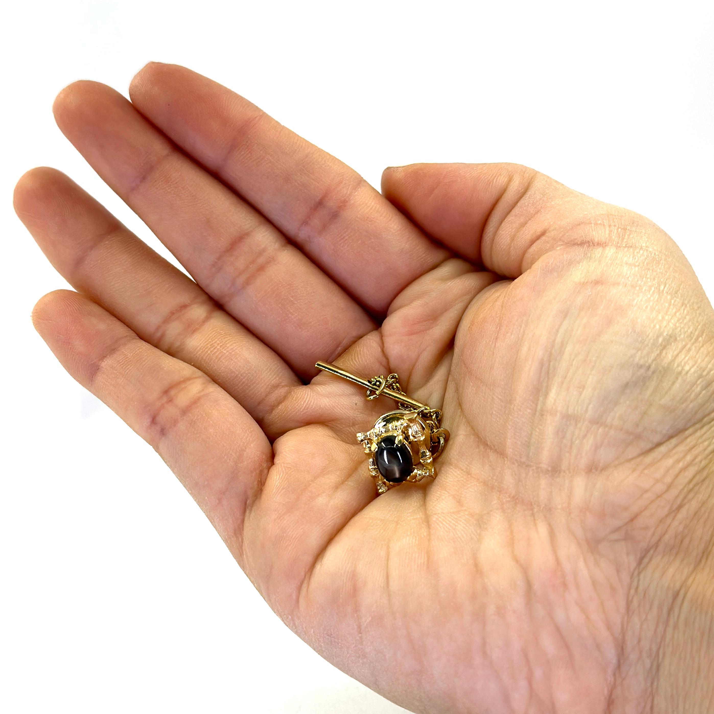 14 Karat Yellow Gold Tie Tack Featuring an Oval Black Star Sapphire Weighing Approximately 1.00 Carat. Steel Backing. Finished Weight is 1.9 Grams.