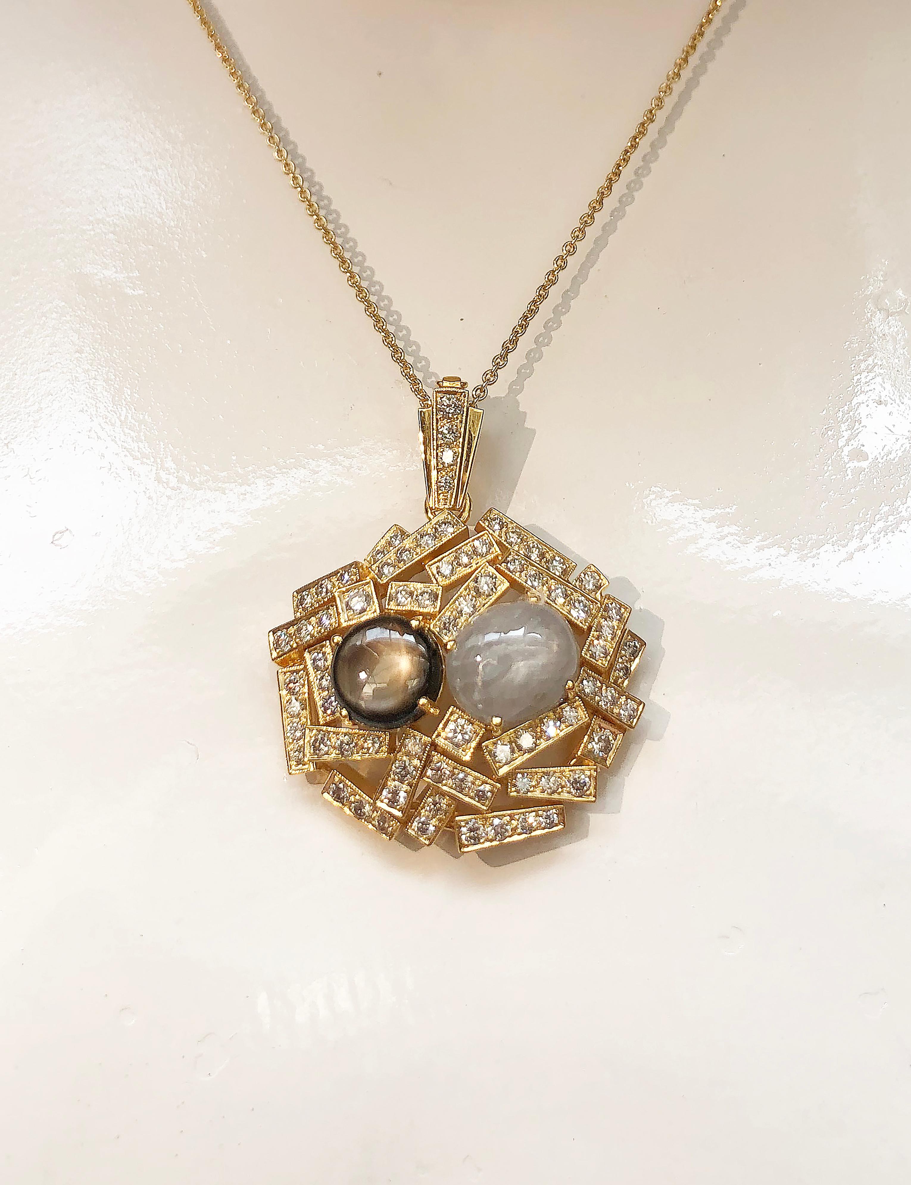 Black Star Sapphire 4.73 carats, Blue Star Sapphire 6.24 carats with Brown Diamond 1.84 carats Pendant set in 18 Karat Gold Settings
(chain not included)

Width:  3.3 cm 
Length: 4.0 cm
Total Weight: 16.55 grams


