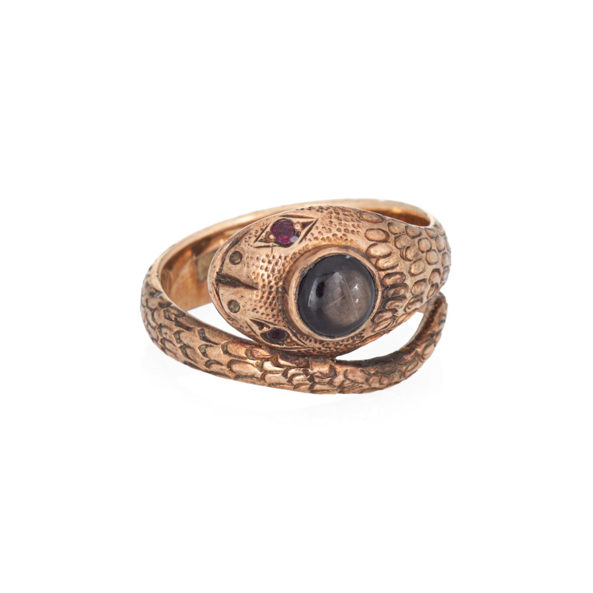 Finely detailed vintage snake ring, crafted in 14 karat rose gold (circa 1960s to 1970s). 

Star sapphire measures 4mm. Two small 1mm rubies are set into the eyes. The sapphire is in very good condition and free of cracks or chips.       

For