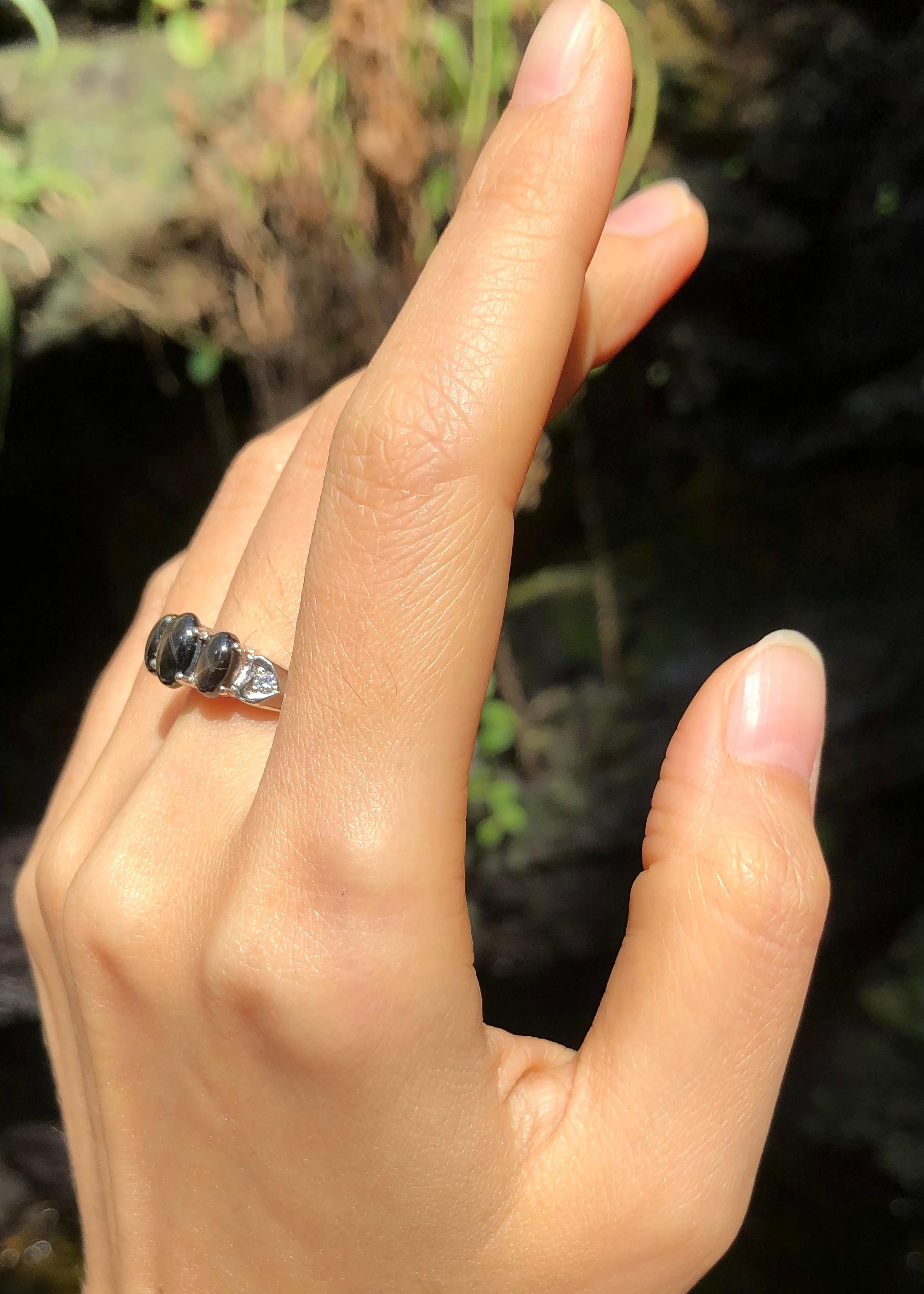 Black Star Sapphire with Cubic Zirconia Ring set in Silver Settings

Width:  1.3 cm 
Length: 0.7 cm
Ring Size: 51
Total Weight: 3.08 grams

*Please note that the silver setting is plated with rhodium to promote shine and help prevent oxidation. 